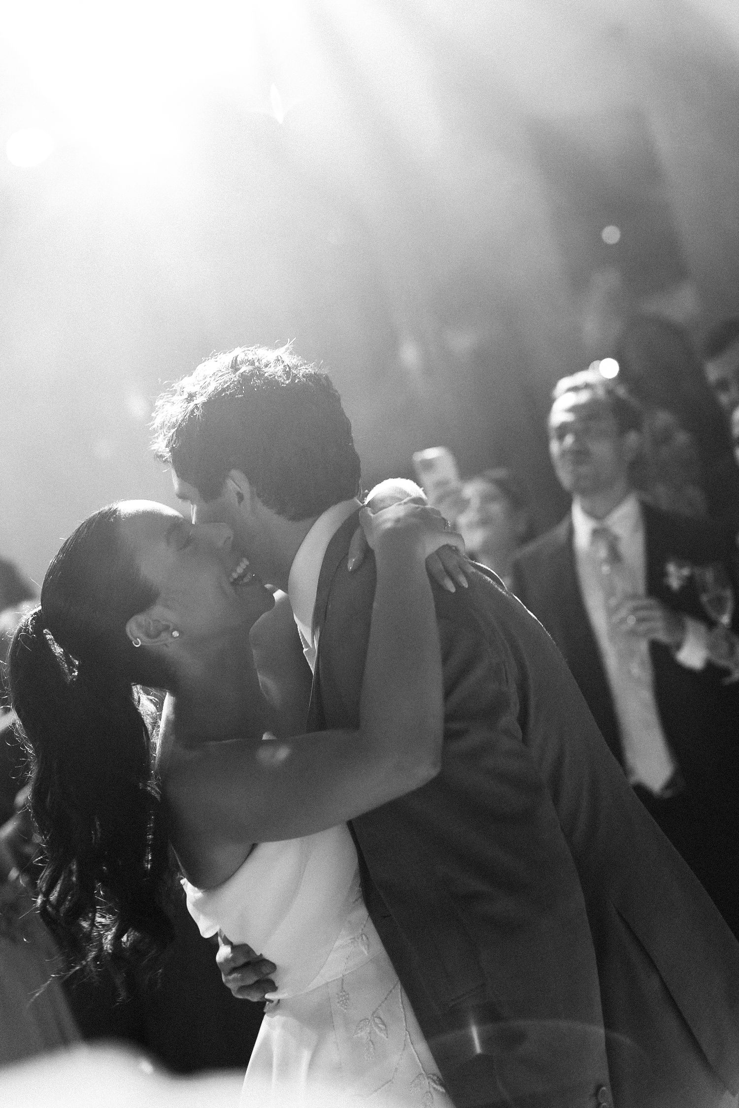 A romantic black and white photo sequence shows a couple sharing their first dance at a wedding reception.
