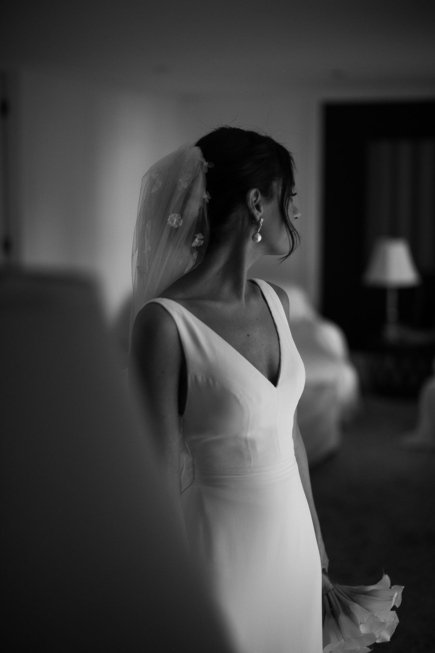Black and white image sequence of a bride in an elegant white wedding dress silhouetted against glowing window light.