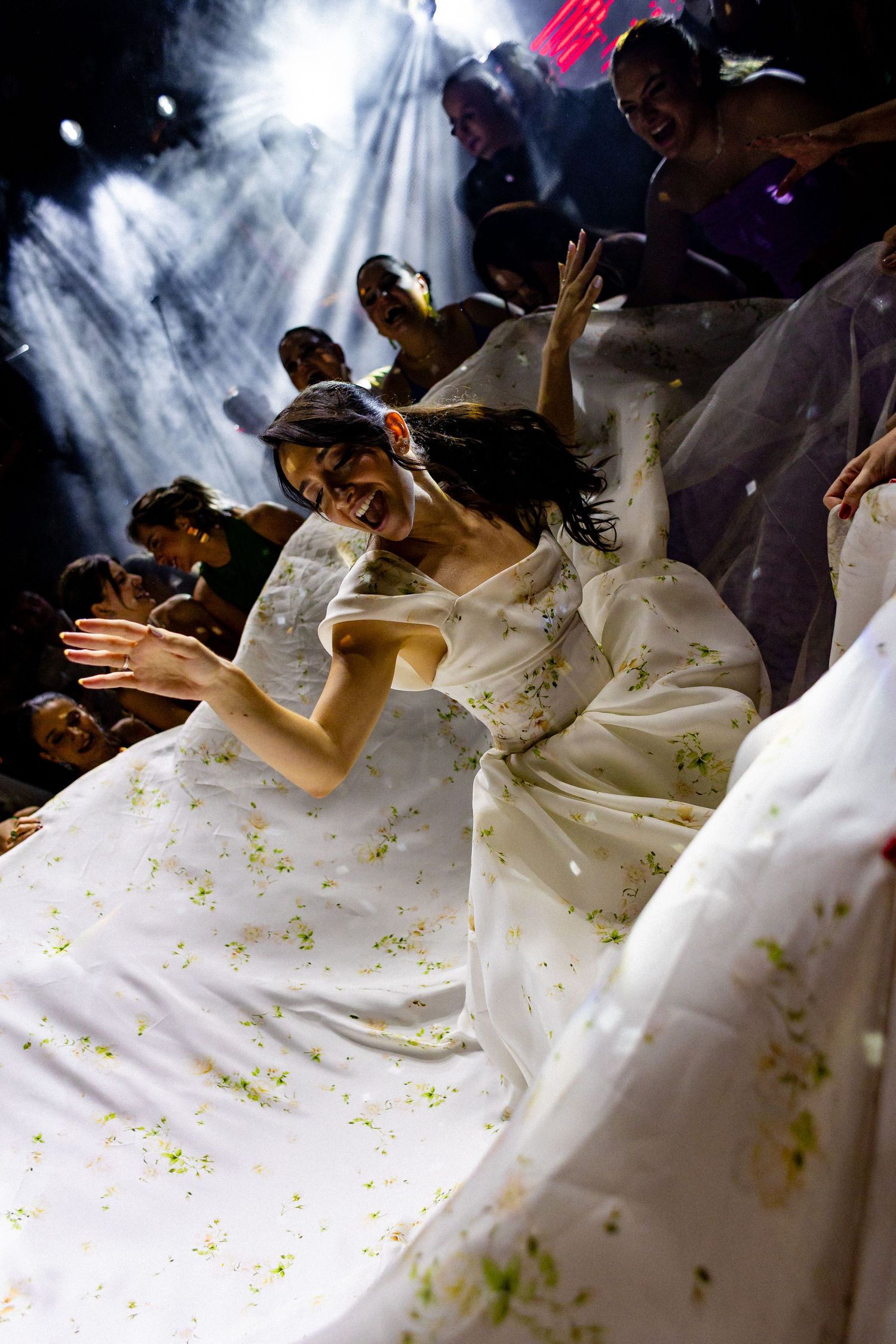 A sequence showing a bride in a white dress twirling and dancing during a wedding celebration.