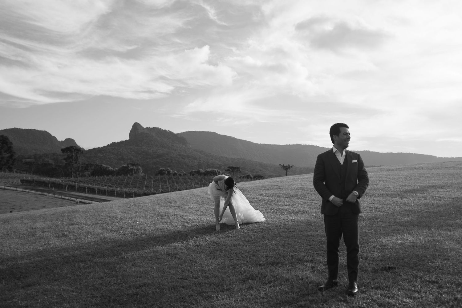 A series of black and white landscape photographs showing rolling hills, mountains and pastoral scenes in a remote setting.