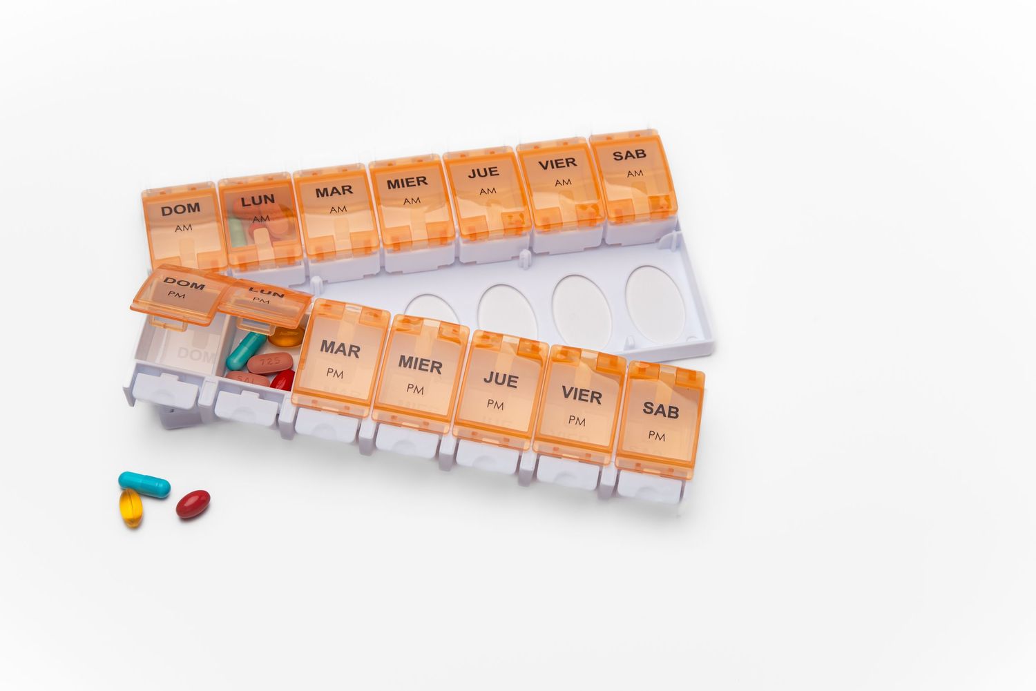 Product shot of an orange twice a day weekly pill organizer