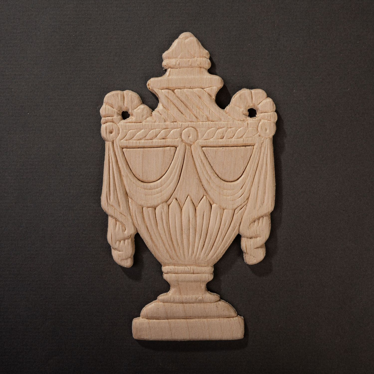 Product photograph of a wooden applique on a dark gray background.