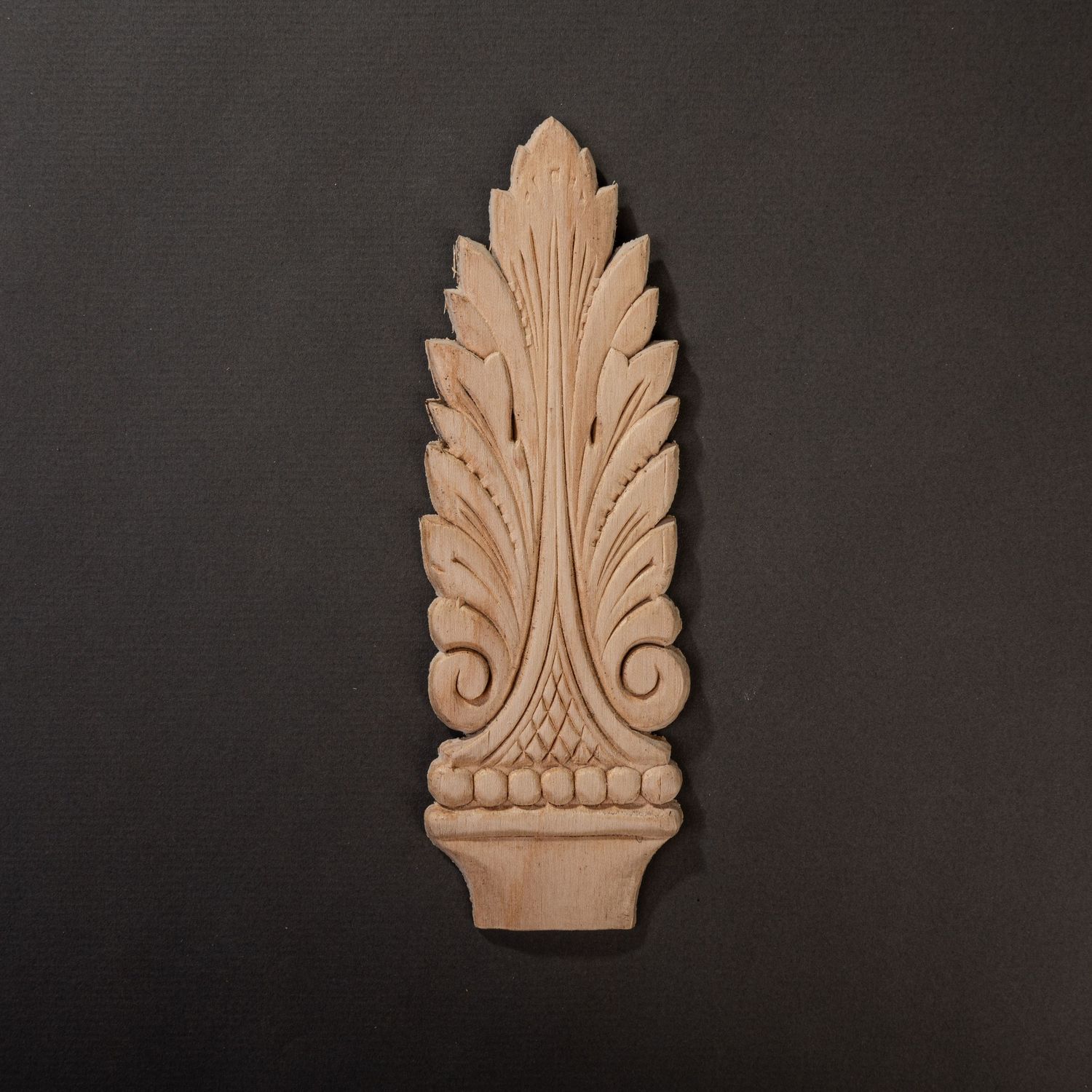 Raw wood applique on a dark gray background.