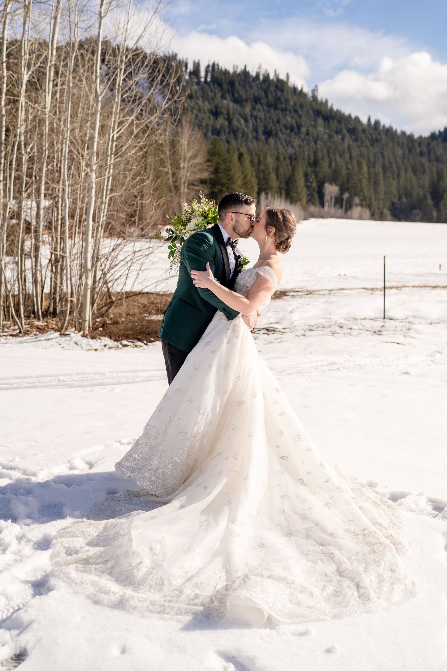 Leavenworth, WA wedding photography  bride and groom kissing with mountain backdrop