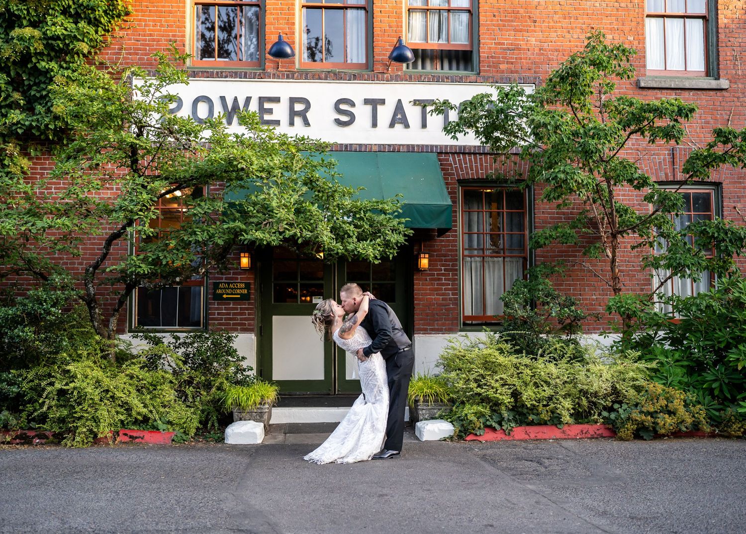 Newlyweds share a romantic moment outside the Power Station brick building.