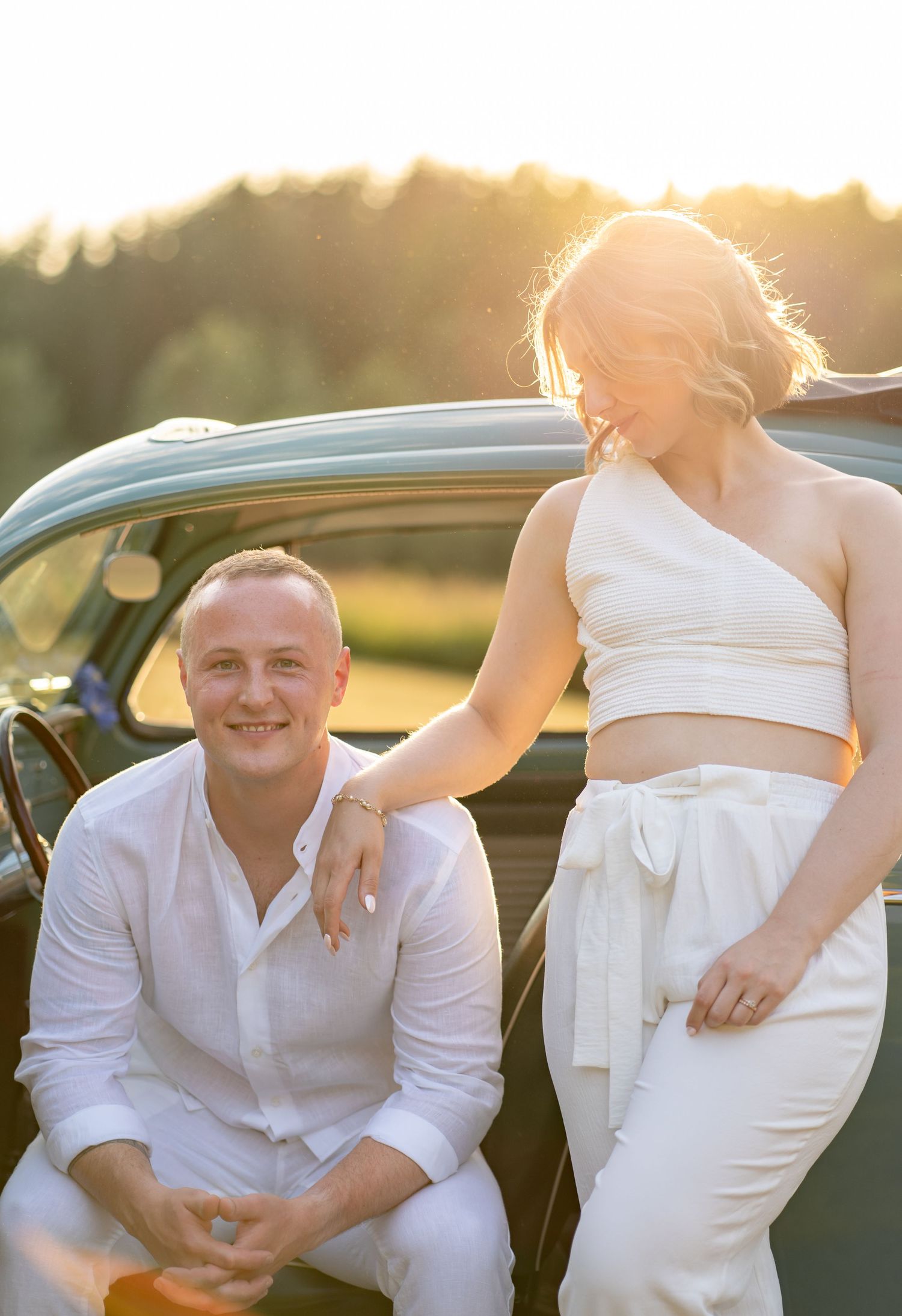 Sunset photoshoot with classic car featuring modern bridal two-piece outfit.