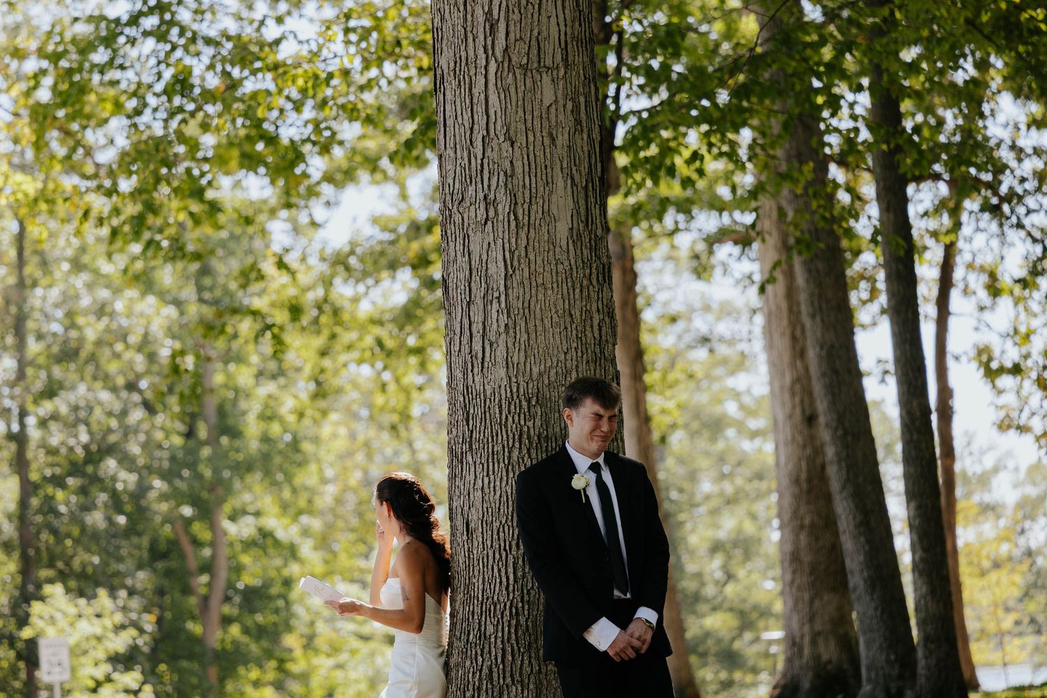 Bride and groom standing among tall trees for a romantic outdoor wedding portrait at Hidden Oak Manor in Indiana.