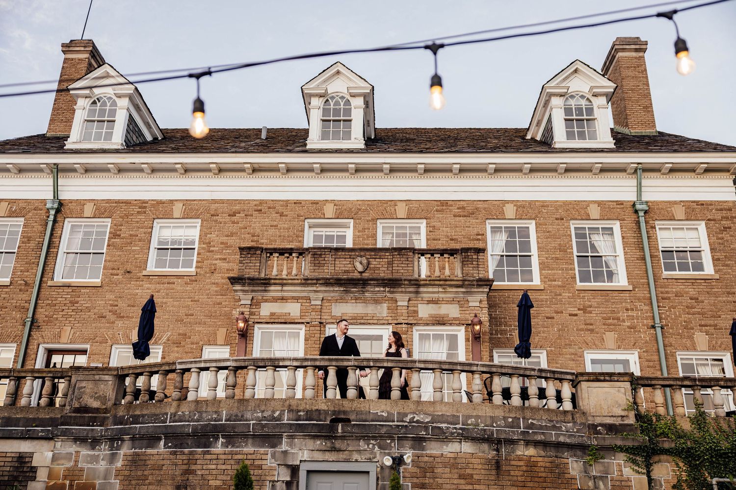 Historic Felt Estate mansion in Saugatuck, Michigan, featuring brick architecture and outdoor string lights for engagement photo inspiration