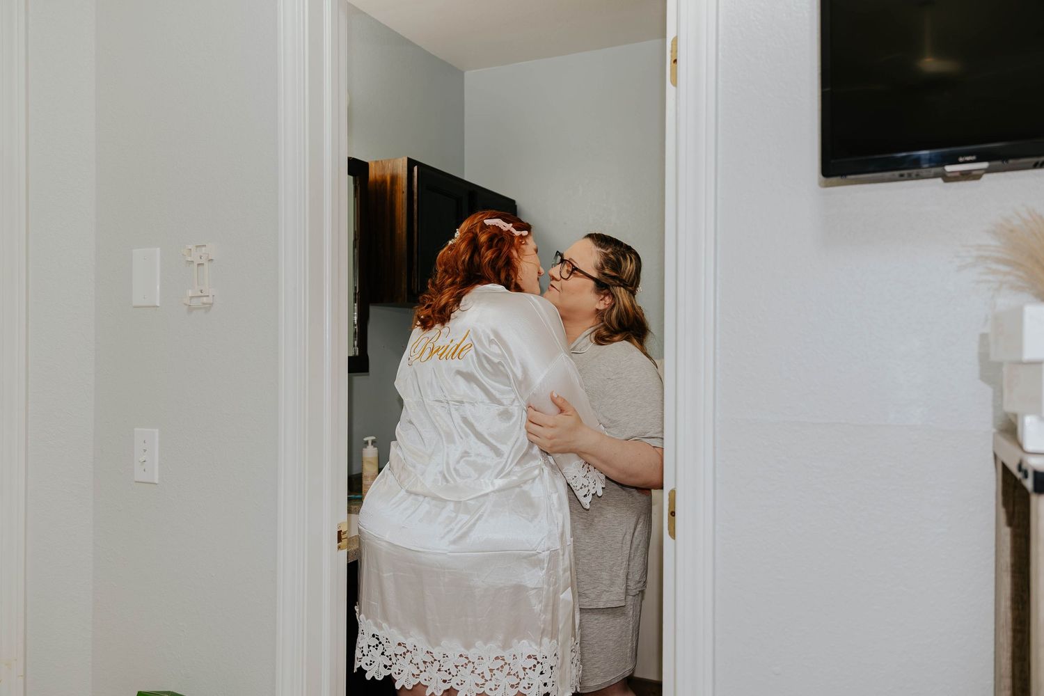 Emotional getting-ready moment as two women embrace before an intimate Michigan elopement ceremony.