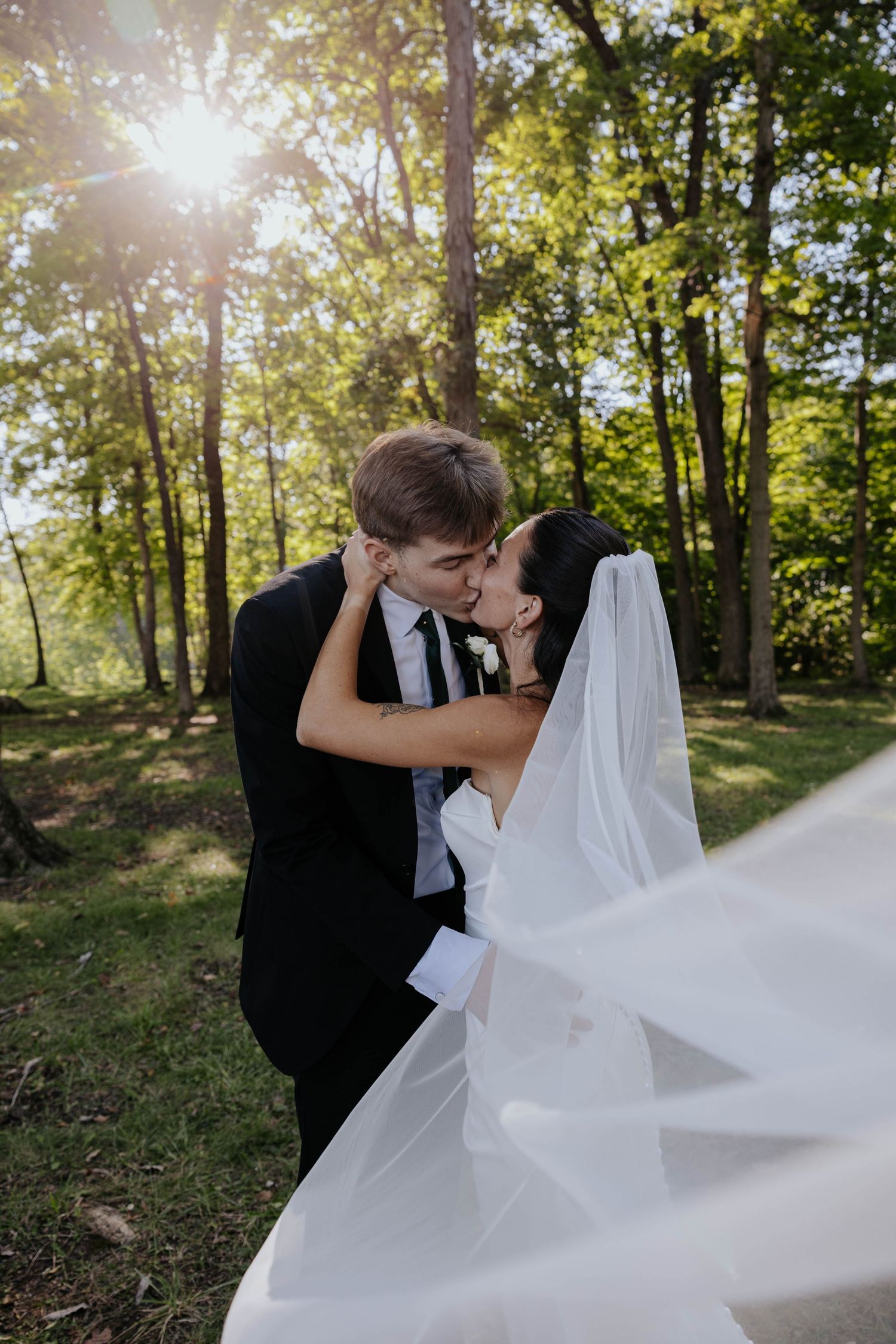 Emotional wedding ceremony moment as a groom wipes away tears while waiting for his bride in Battle Creek, Michigan.
