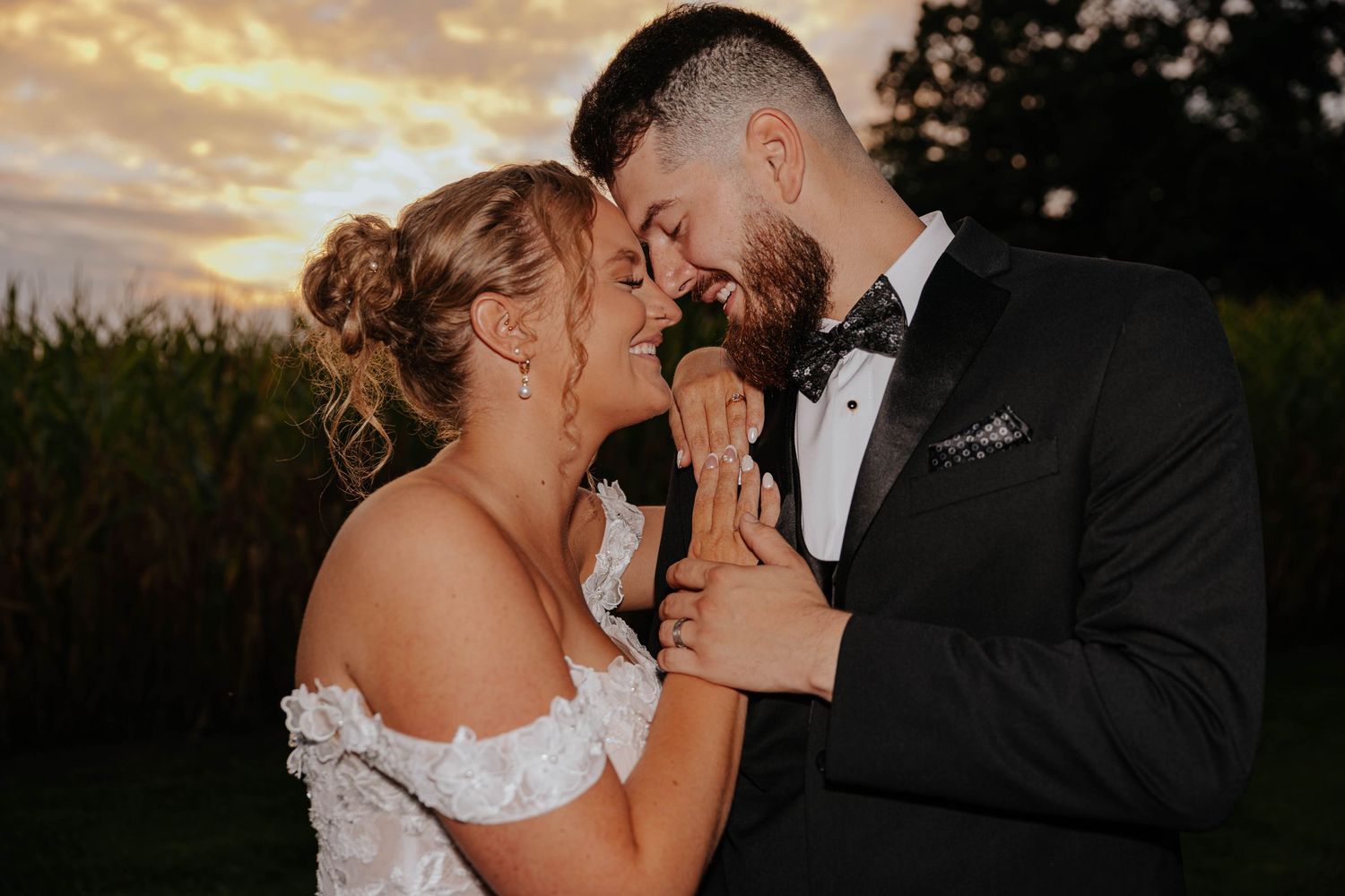 Romantic sunset wedding portrait of a bride and groom sharing a tender moment at Res-Les Farms in Michigan.