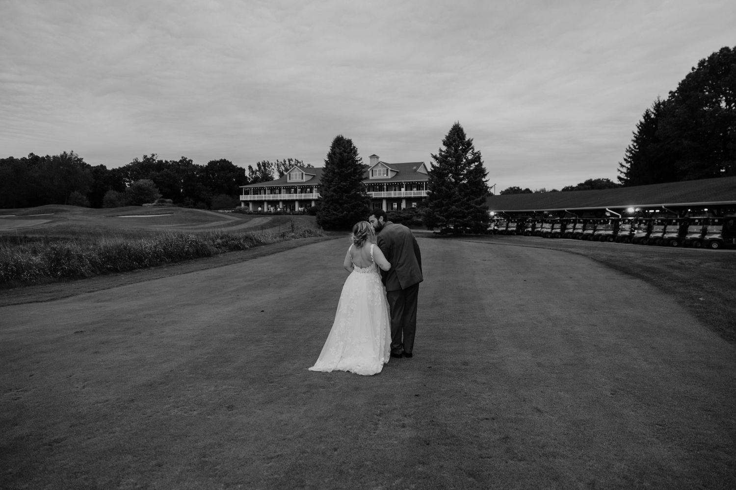 Timeless black and white wedding portrait of a bride and groom standing together on the grounds of Hawk Hollow in Lansing, Michigan.