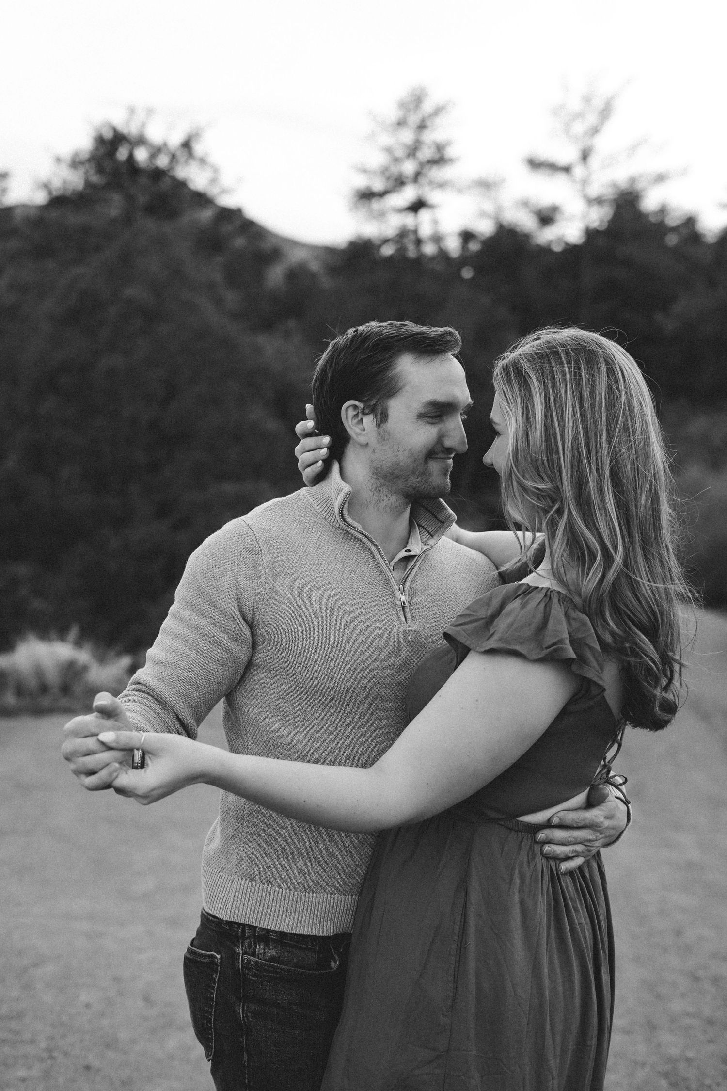 Couple dancing together on an adventure photo session at Garden of the Gods in black and white.