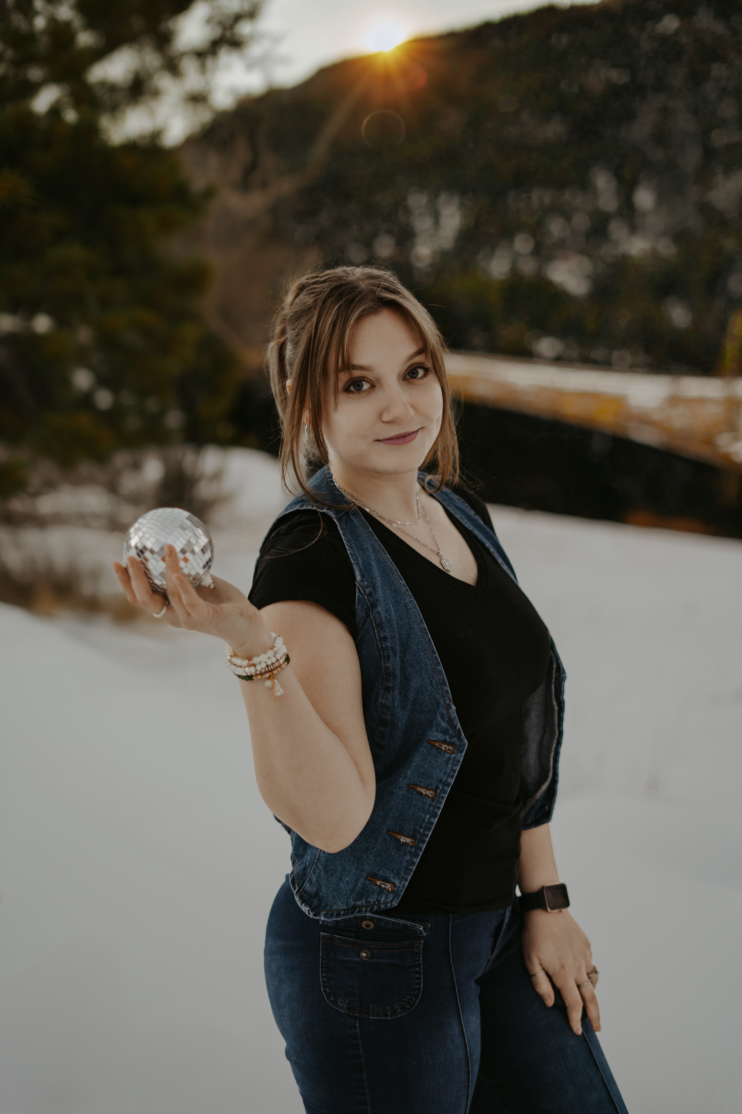 Hannah Michelle Photography branding smiling at the camera and holding a disco ball at Lake Isabel in Colorado.