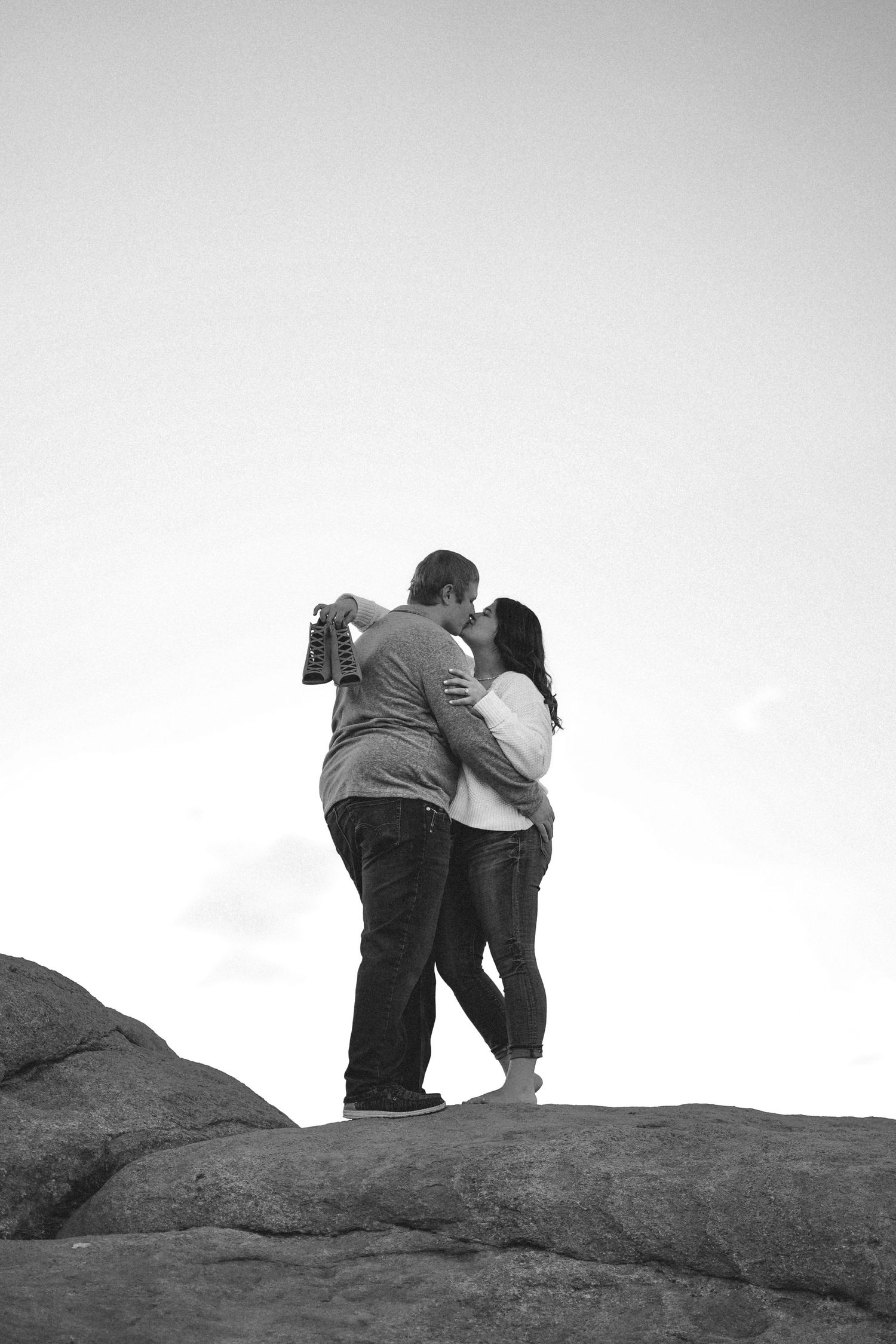 Scenic mountain landscape with loving hands reaching towards each other in black and white at Garden of the Gods.