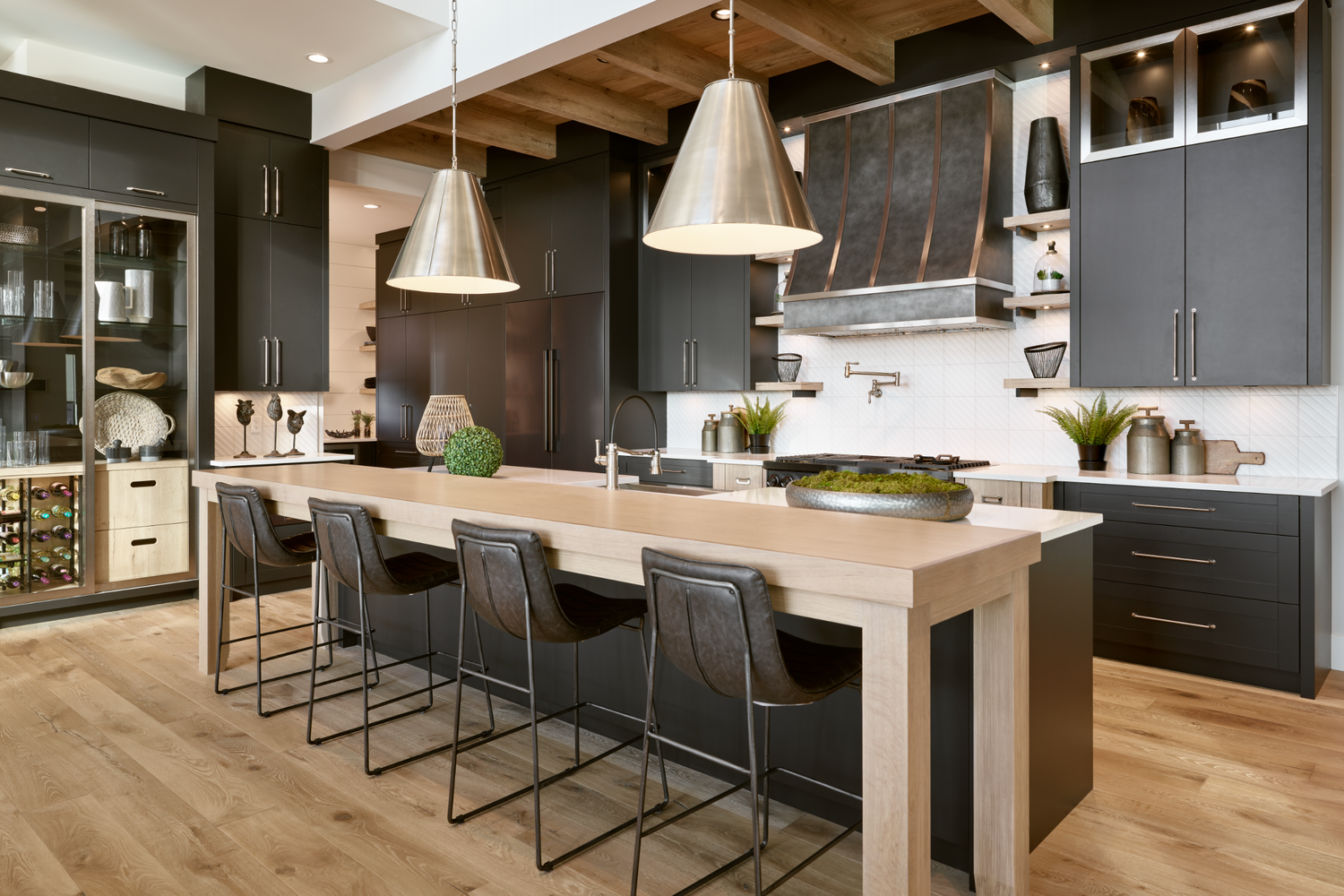 Open concept kitchen with hardwood floors, dark cabinetry and natural light, Calgary interior photographer