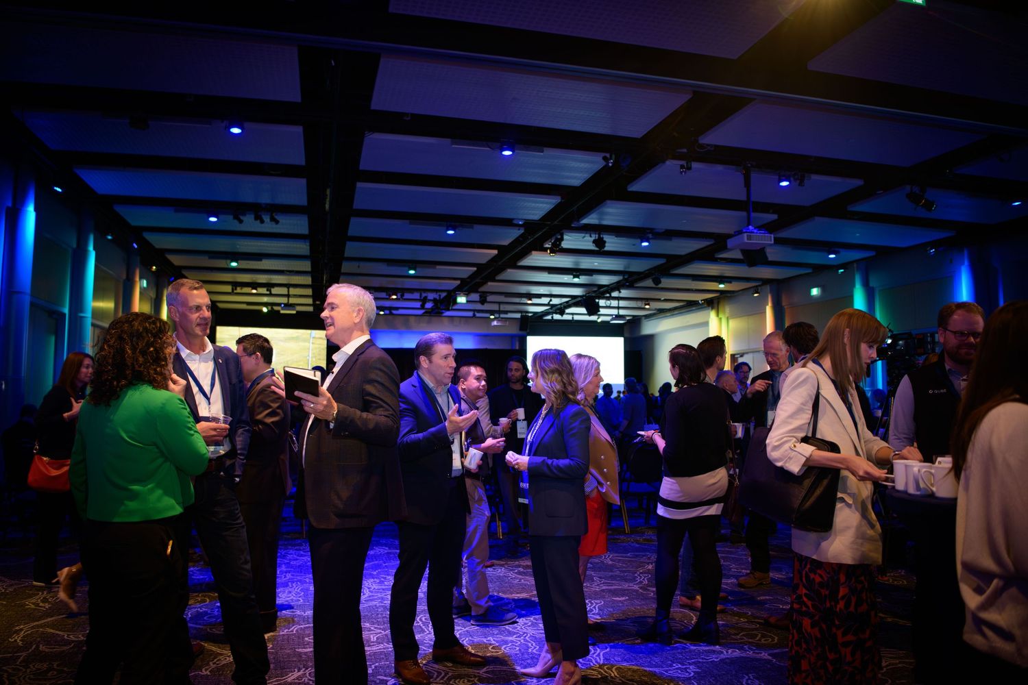 Wide shot of event guests mingling at corporate event, Calgary event photographer