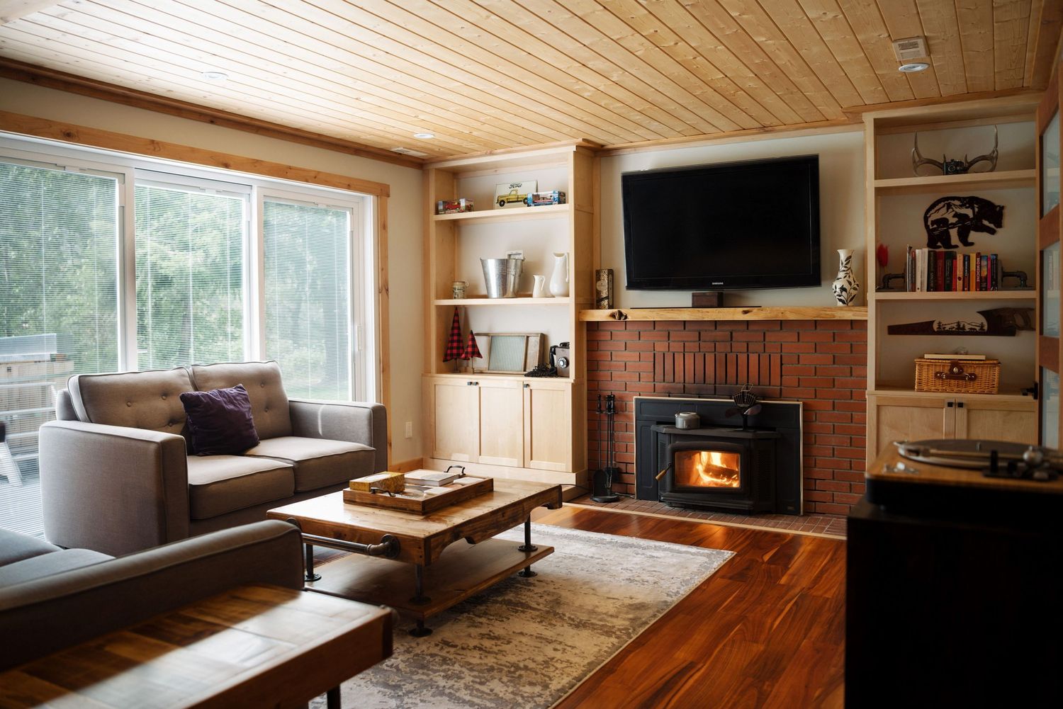 Cozy wooden cabin living room with wood burning stove and natural light, Calgary interior photographer