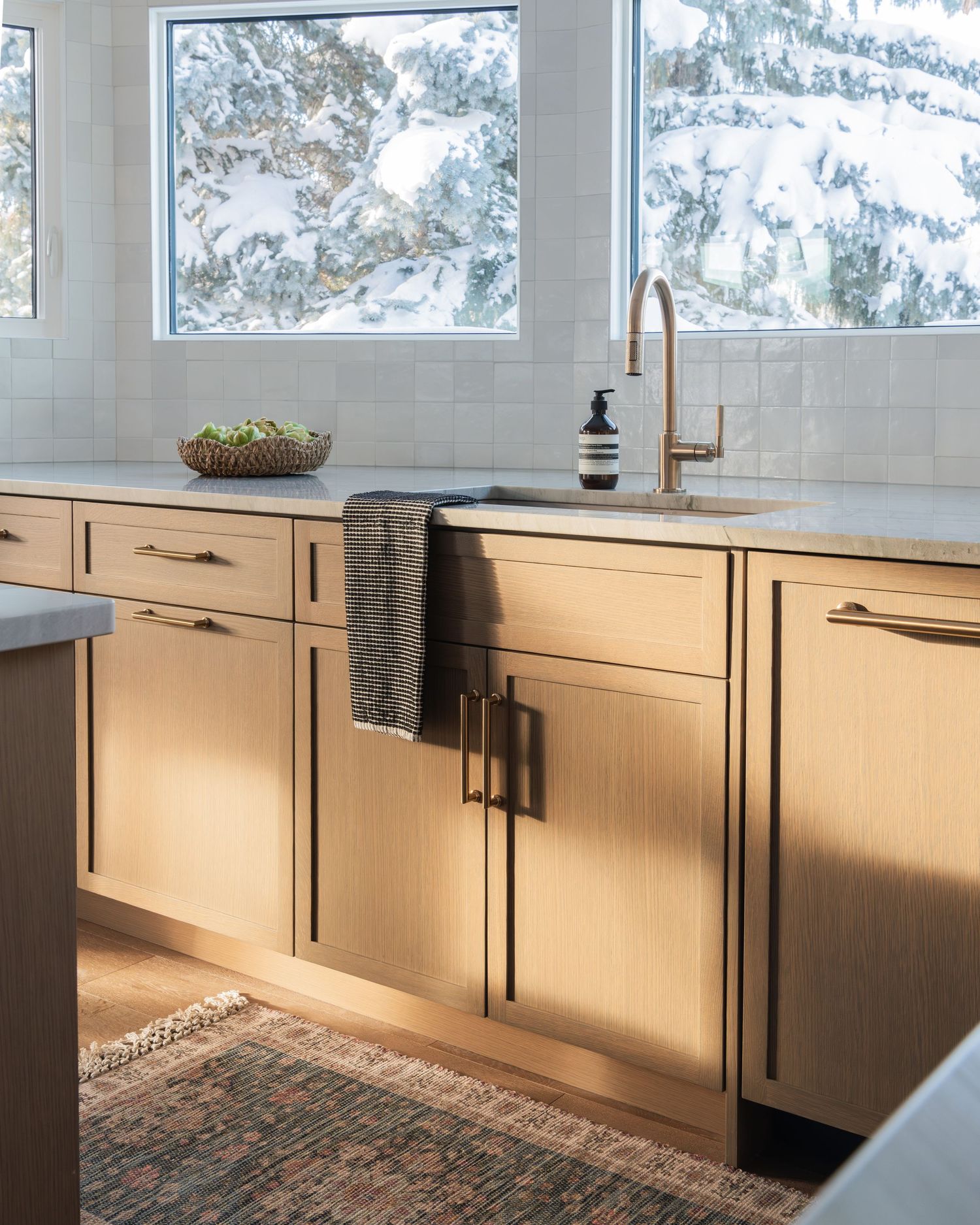 Modern white kitchen with quartz countertops, and wooden accents Calgary interior photographer