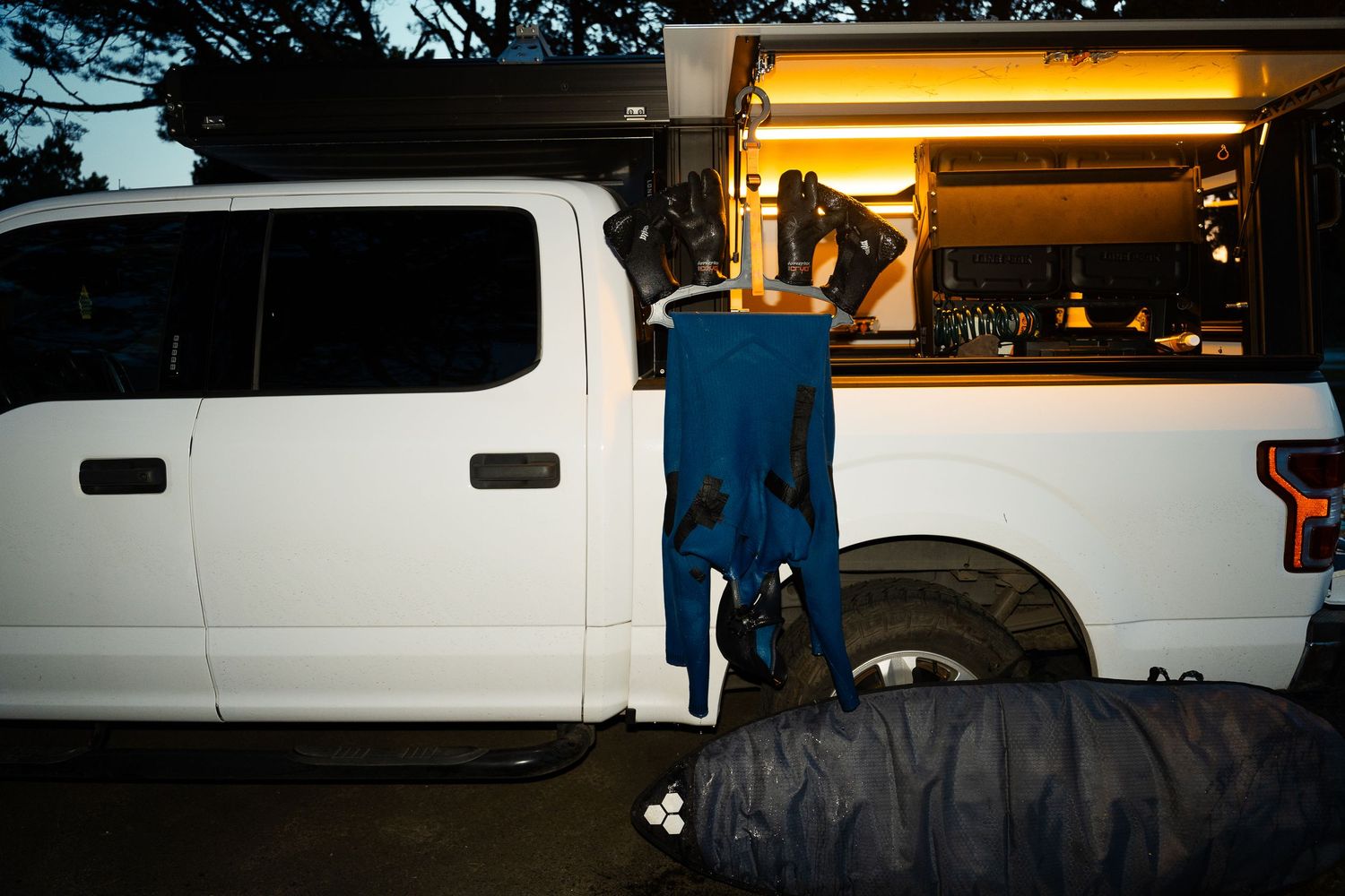 Lone peak side compartment with wetsuit hanging to dry on c-monsta hanger