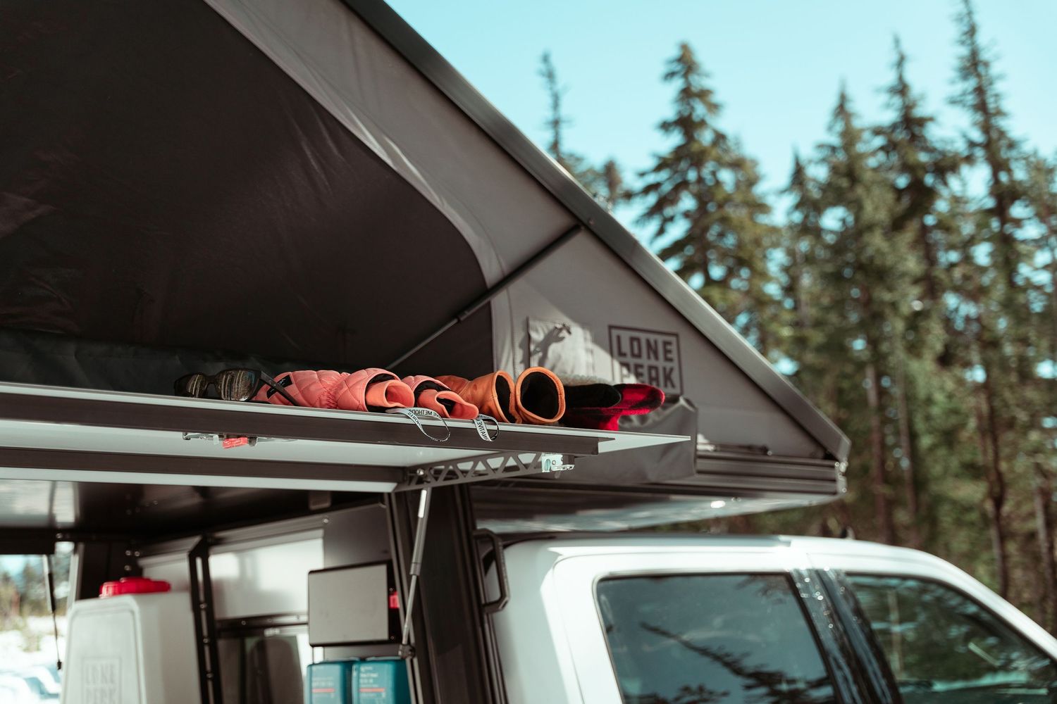 A series of images showing a camper van conversion process including interior construction and storage solutions.