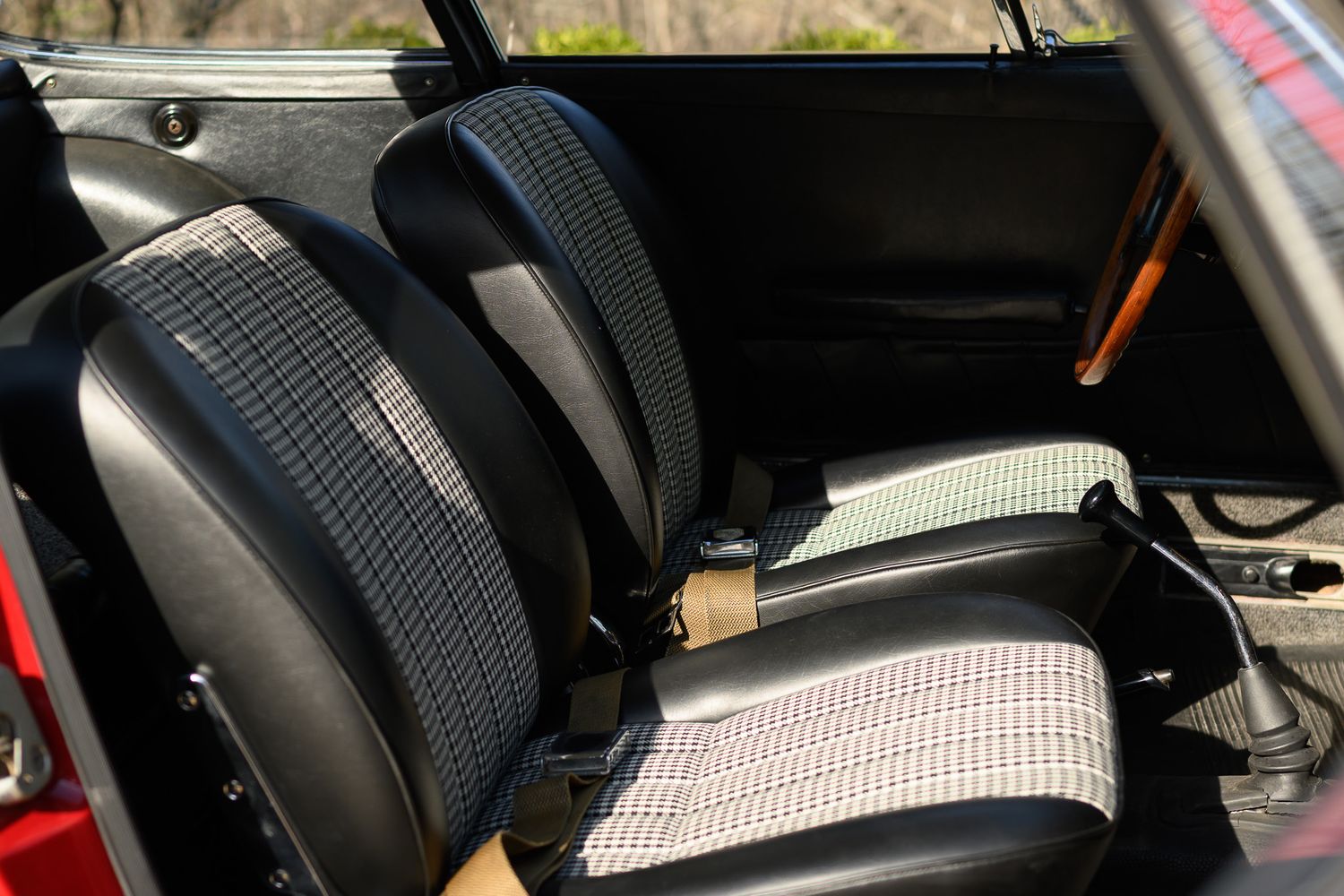 Classic Porsche 911 interior bucket seats with black leather and houndstooth fabric upholstery.