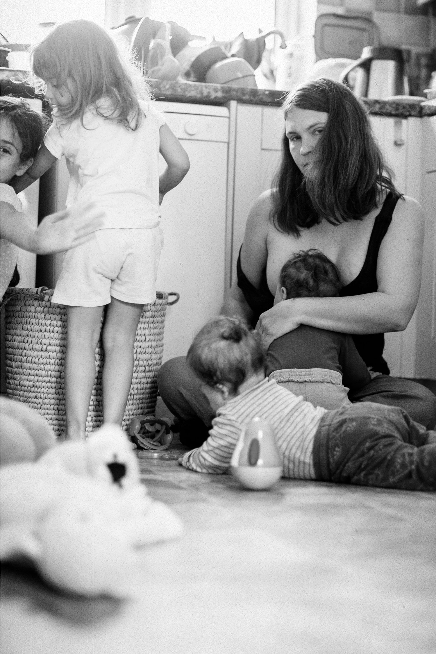 A tired mother of four in the kitchen. Self portrait of The Mother's Eye photographer, Gloria Kurnik. Beckenham, South East London.