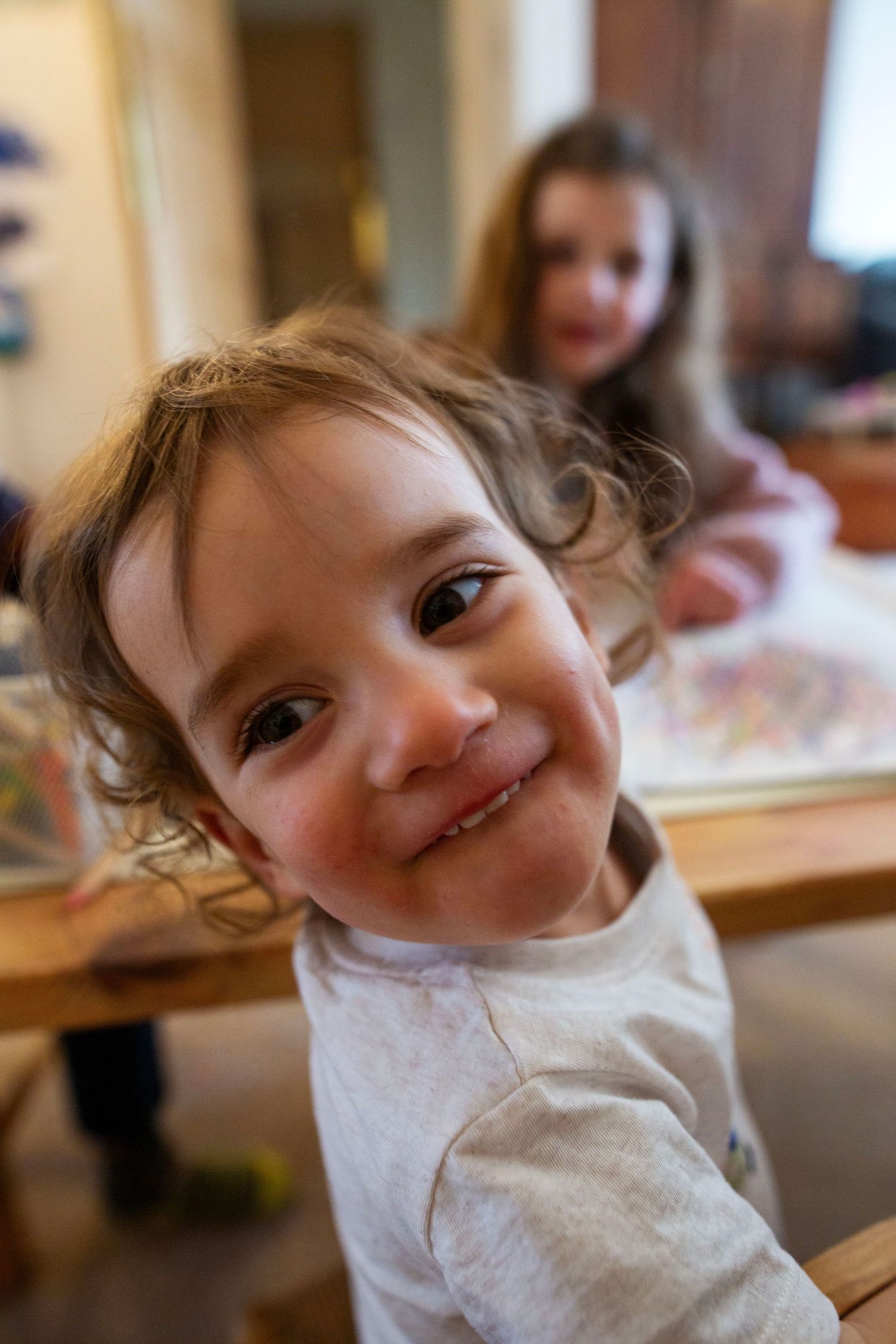Girls drawing during a candid and fun documentary family and childhood photoshoot by The Mother's Eye in Denmark Hill, South East London.