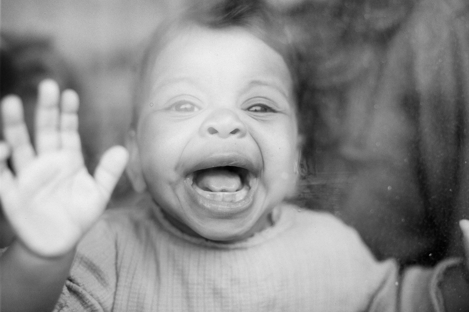 A smiling toddler, a candid and fun documentary family and childhood photoshoot by The Mother's Eye in Beckenham, South East London.