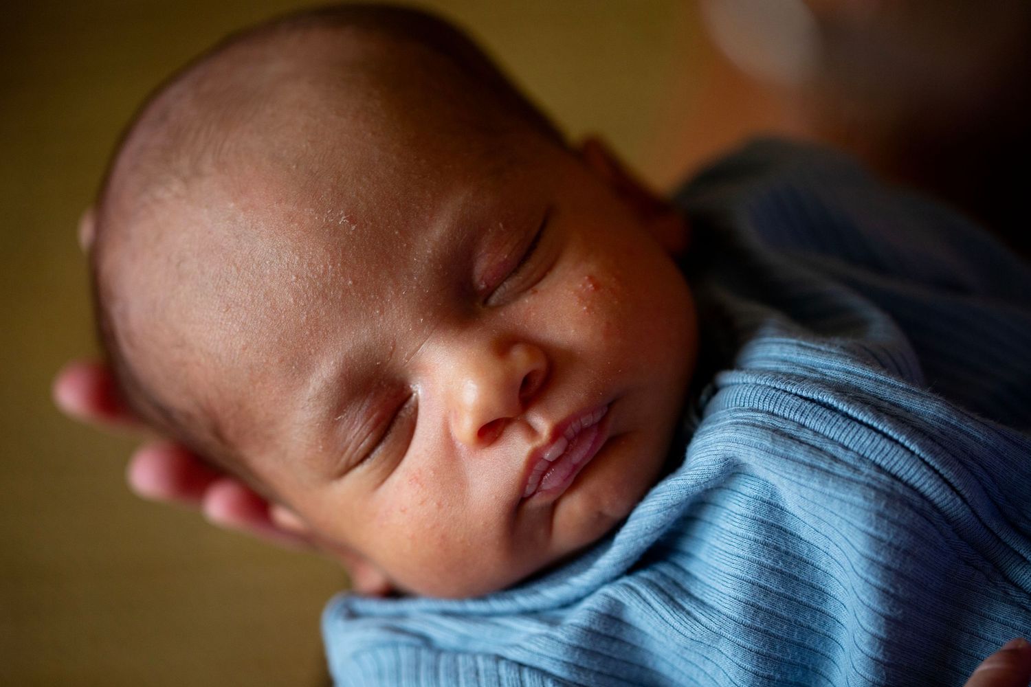 Close up of a sleeping newborn on mums hands. Postpartum and Fourth Trimester photography by The Mother's Eye, Crystal Palace,  London.
