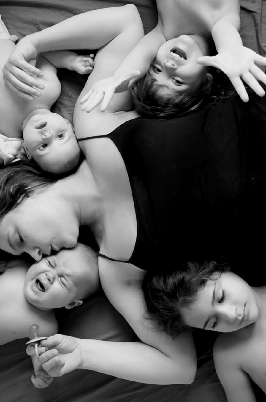The Mother's Eye photographer laying down surrounded by her 4 kids. Motherhood photography by The Mother's Eye in Southwark, London.