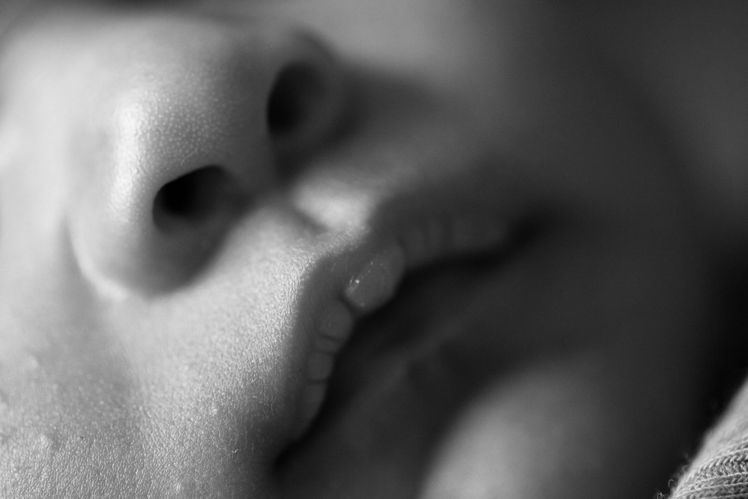 Close up of newborn's lips. Poetic documentary childhood, newborn and family photography by The Mother's Eye, Battersea, South East London.