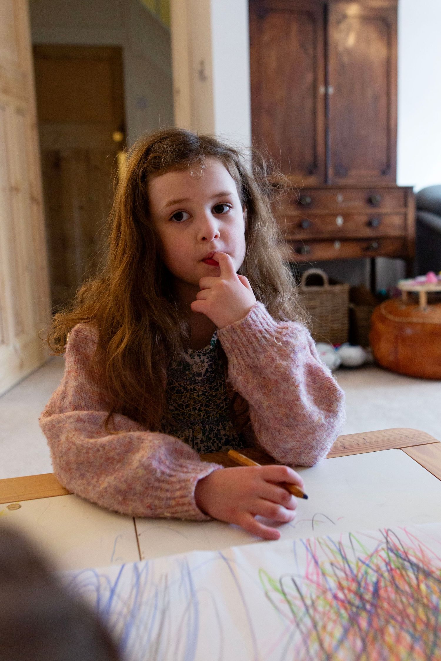 A girl drawing during a candid and fun documentary family and childhood photoshoot by The Mother's Eye in Denmark Hill, South East London.