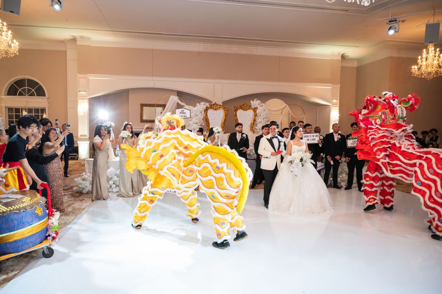 Traditional Chinese lion dancers perform at an elegant wedding reception ballroom celebration.