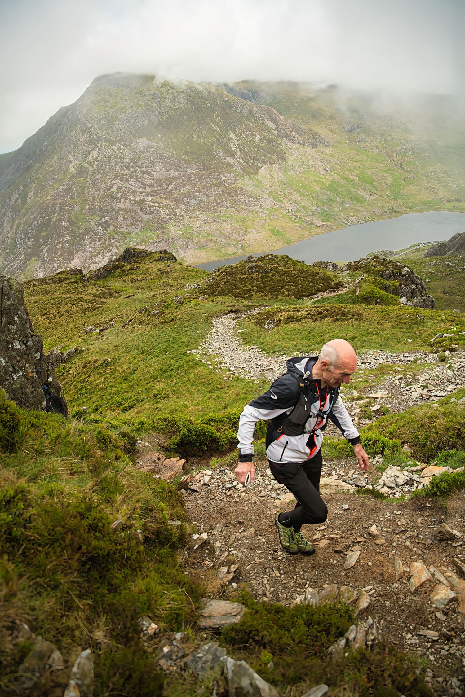 Competitor during the Welsh 1000 m race enjoying the steep mountains of Ogwen and the heavy rain and wind of the Snowdonia National Park