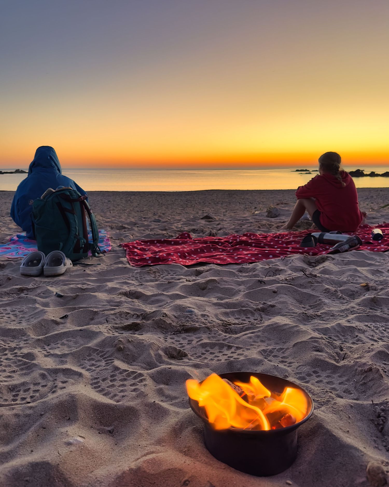 My children watching the sunset over the sea on a peaceful North Wales beach — a moment of calm, beauty, and quiet gratitude for home.