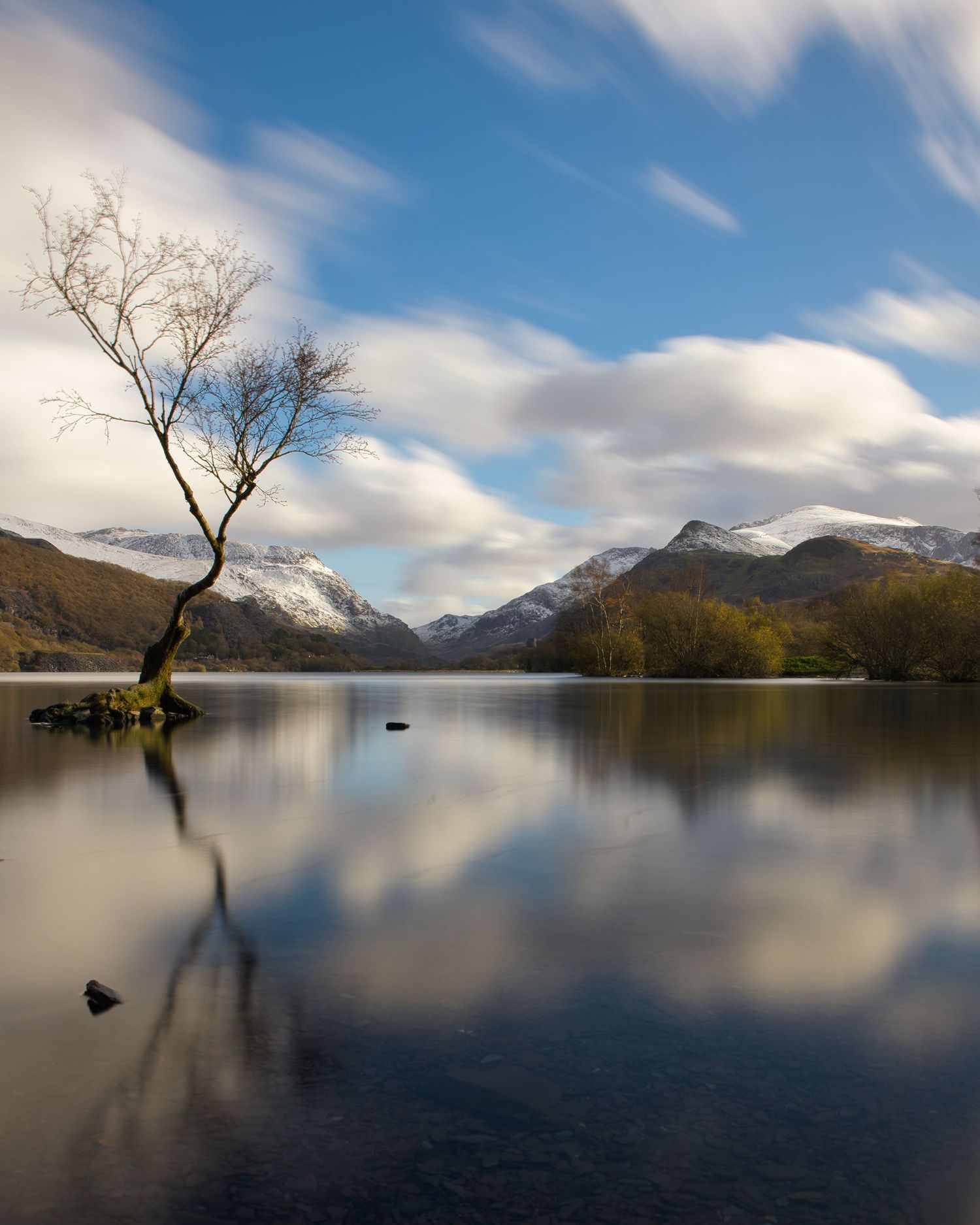 Panoramic view of Snowdonia, North Wales, highlighting rugged mountains, green valleys, and atmospheric Welsh scenery.