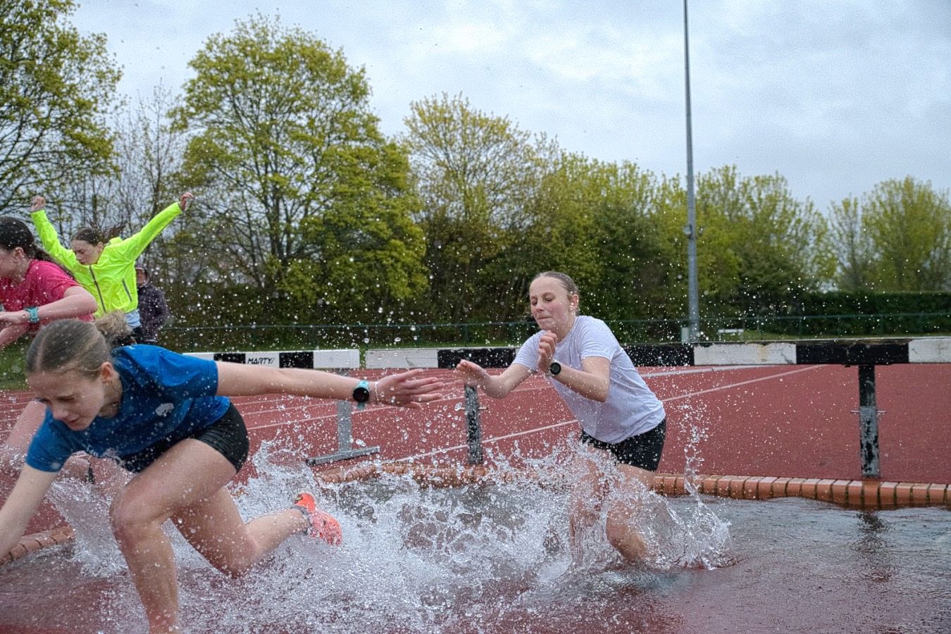 young athletes on the water jump steeplechase