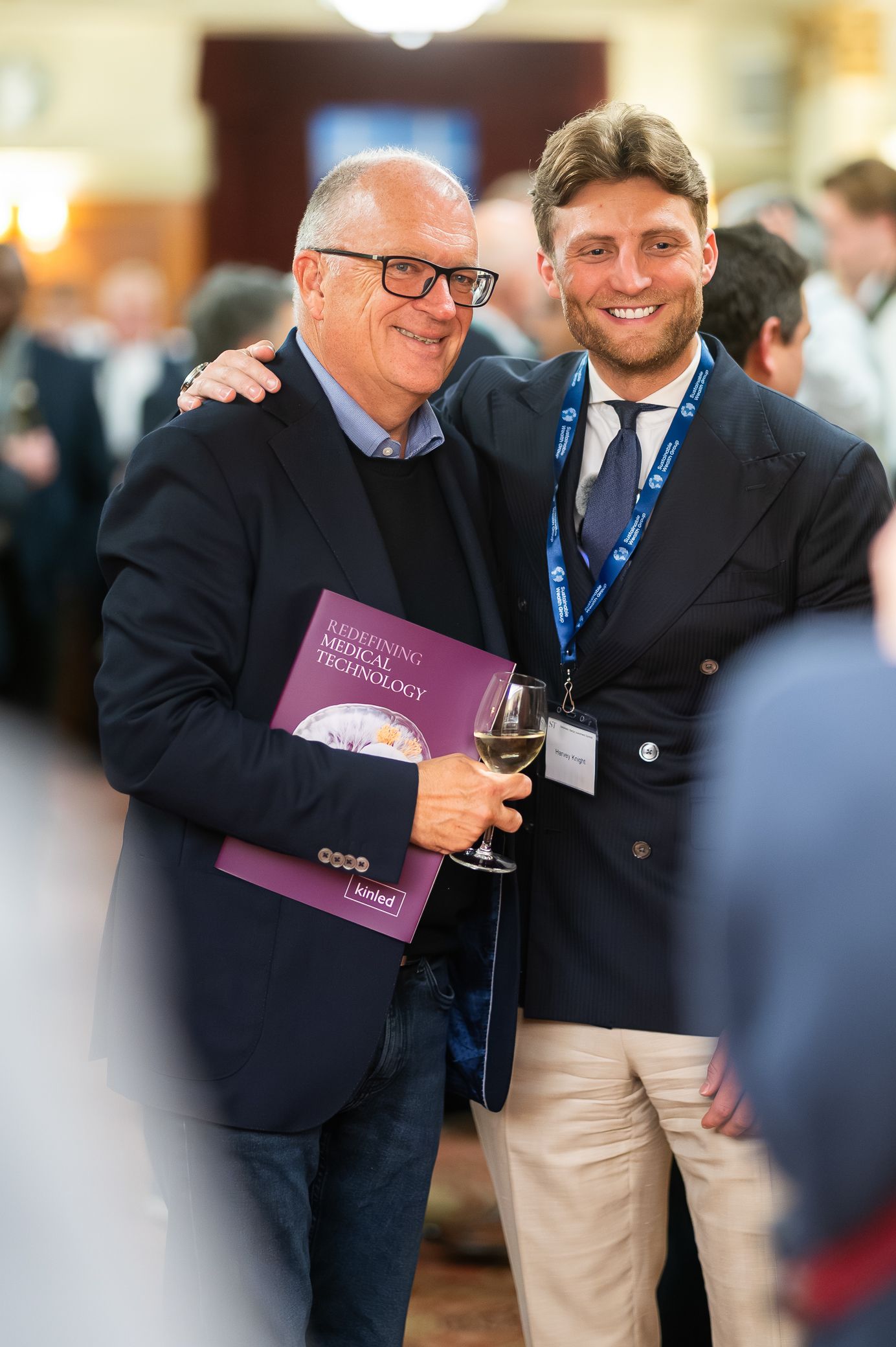Two smiling men posing together at a medical technology conference networking event.