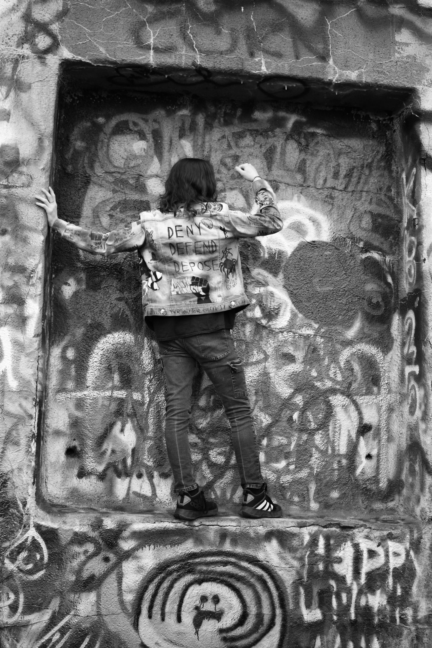 Black and white shot of graffiti wall with urban street art.