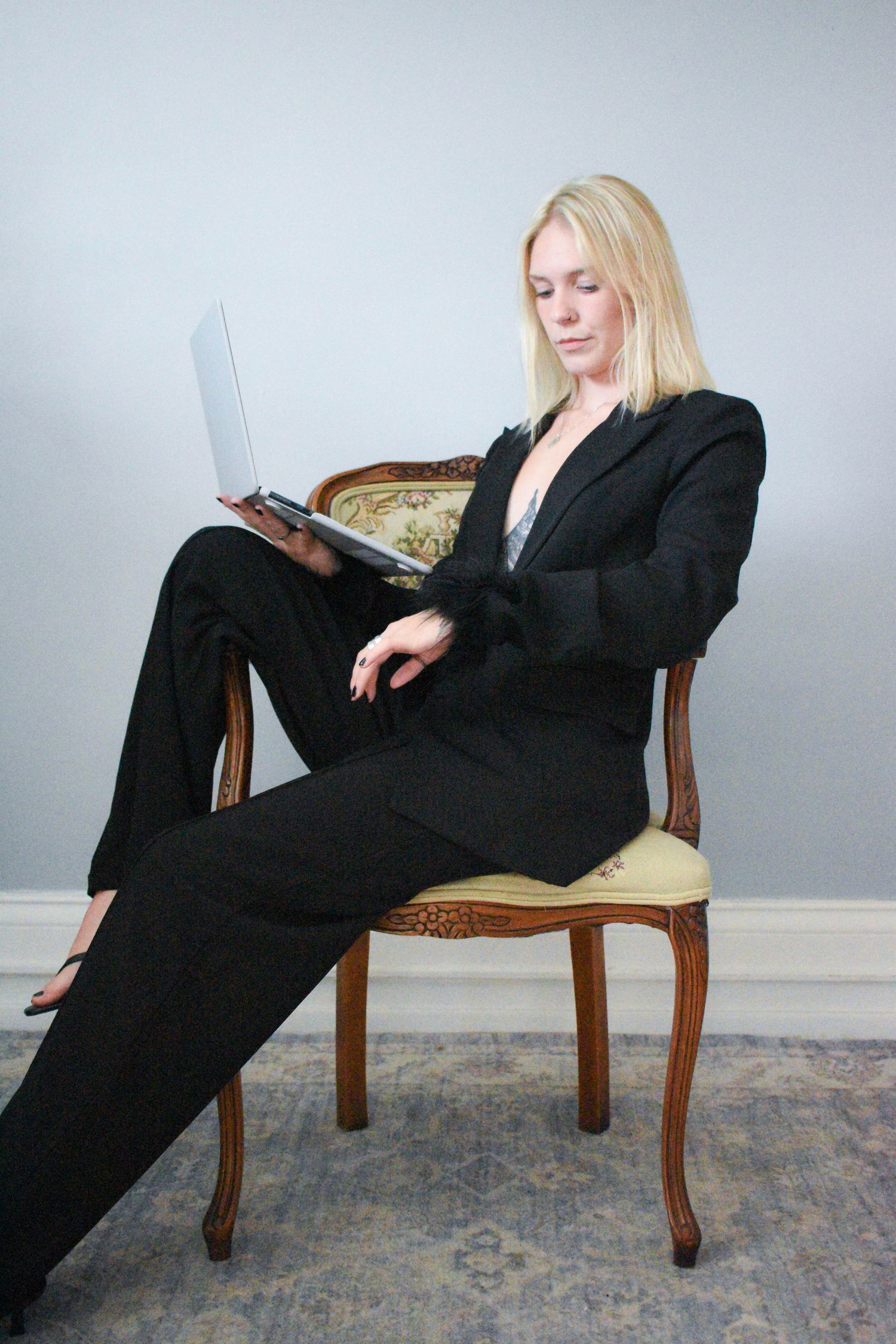 Professional lifestyle shots featuring someone working on a laptop while lounging on a vintage chair.