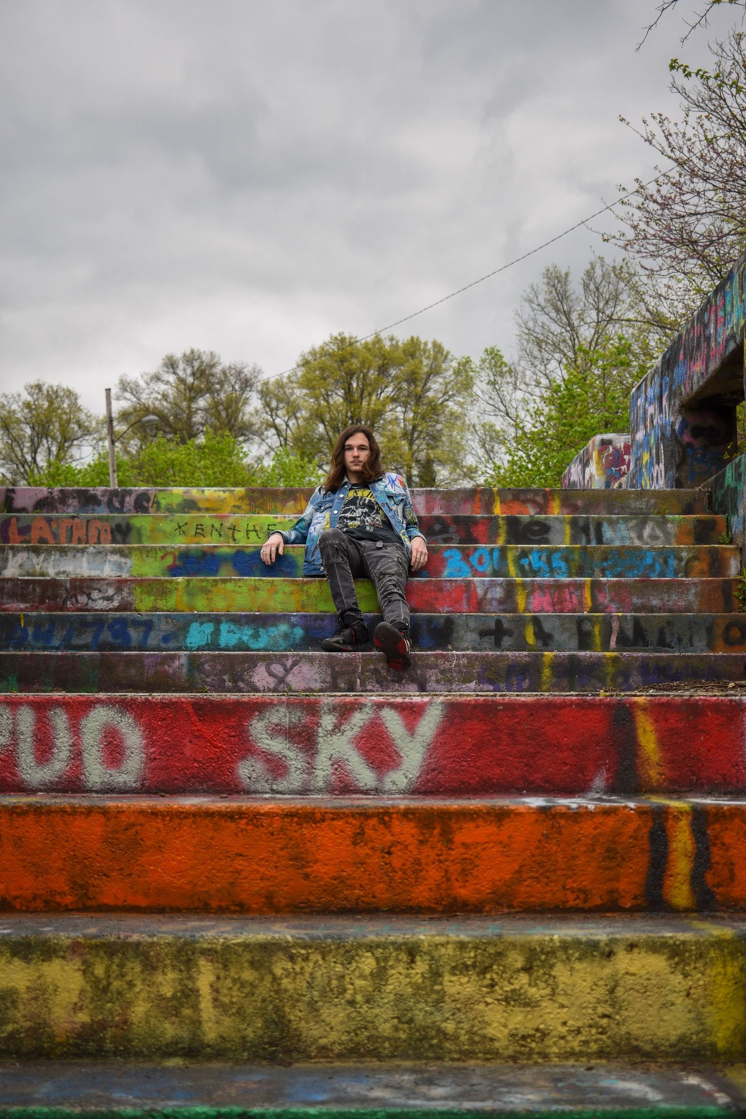 Graffiti-covered concrete steps with colorful street art backdrop.