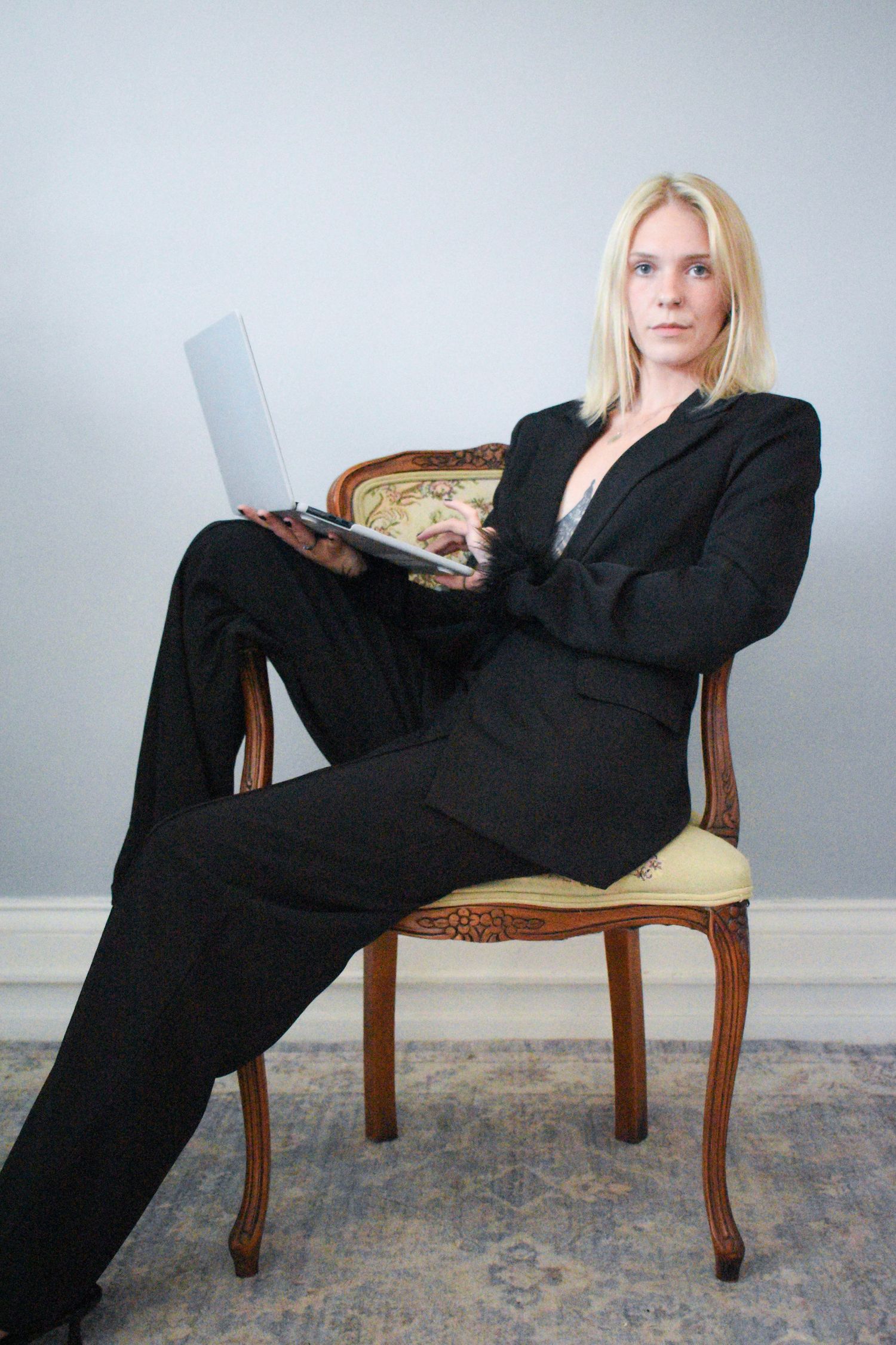 Fashion-forward poses on an antique chair showing different angles and positions.