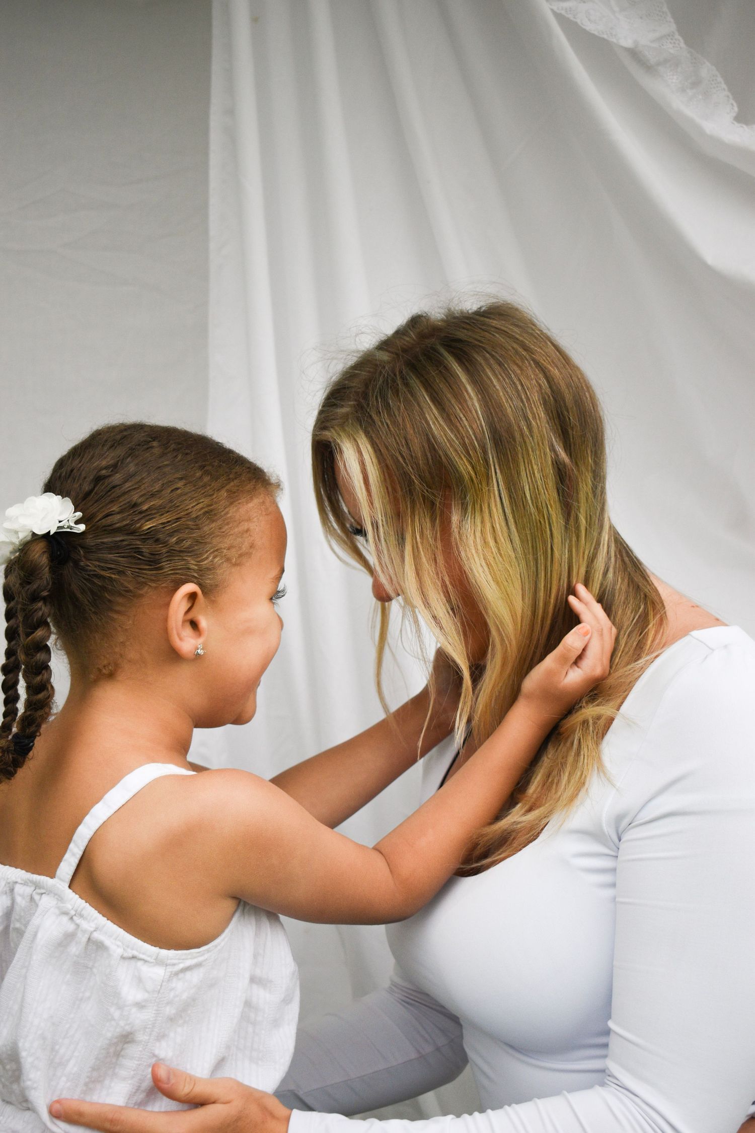Close-up series of tender moments against white backdrop.