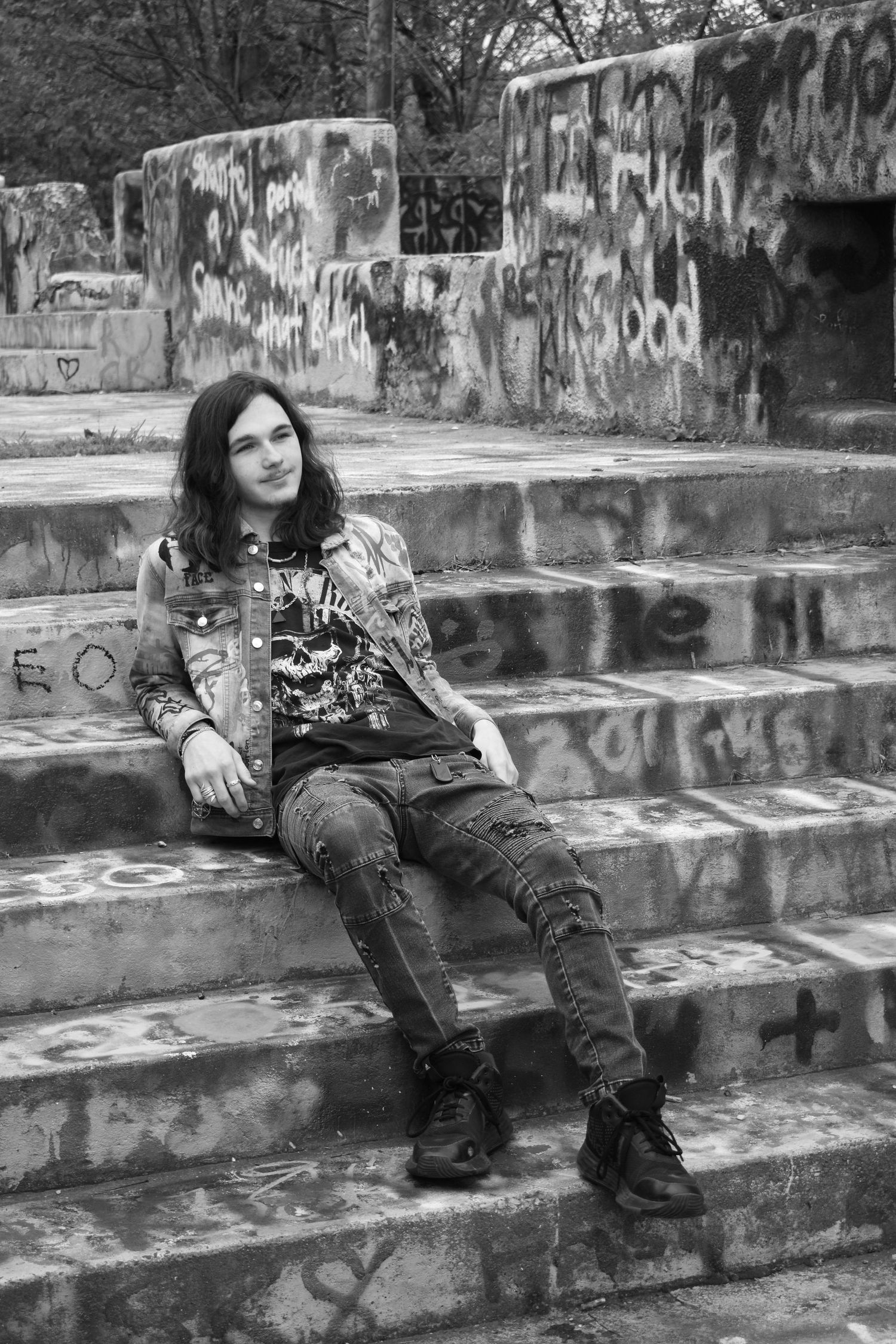 Black and white portrait on graffiti-covered concrete steps.