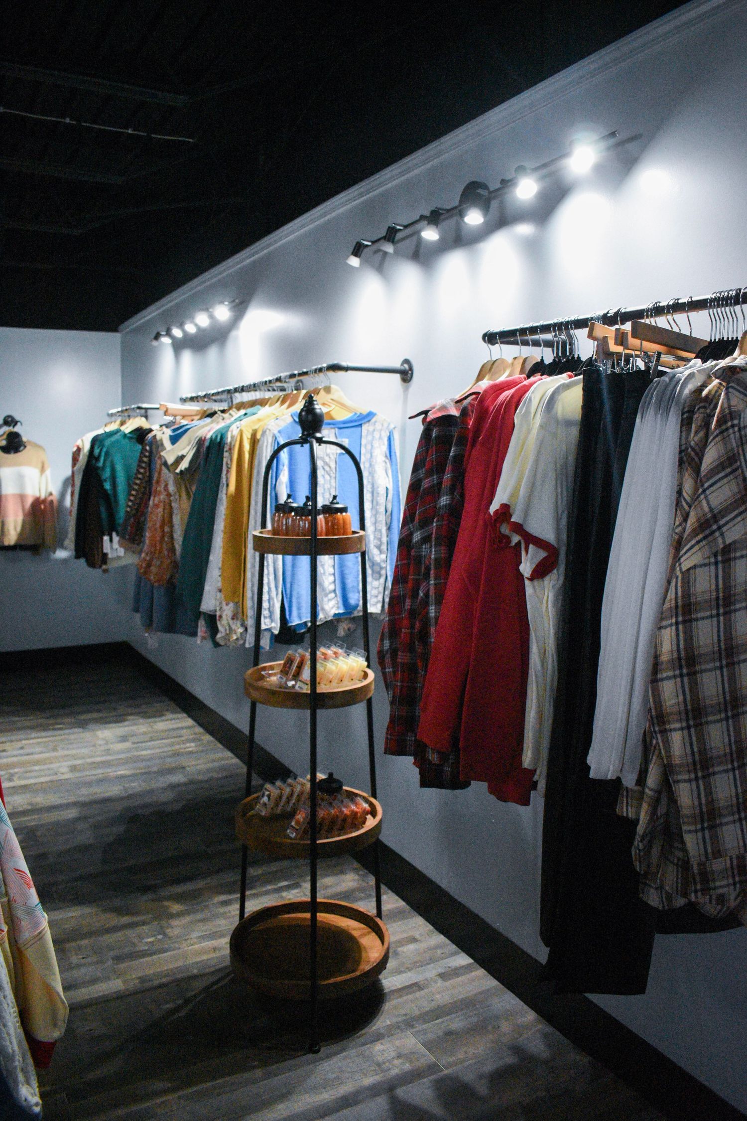 Clothing racks displaying vintage fashion pieces in a modern retail space.