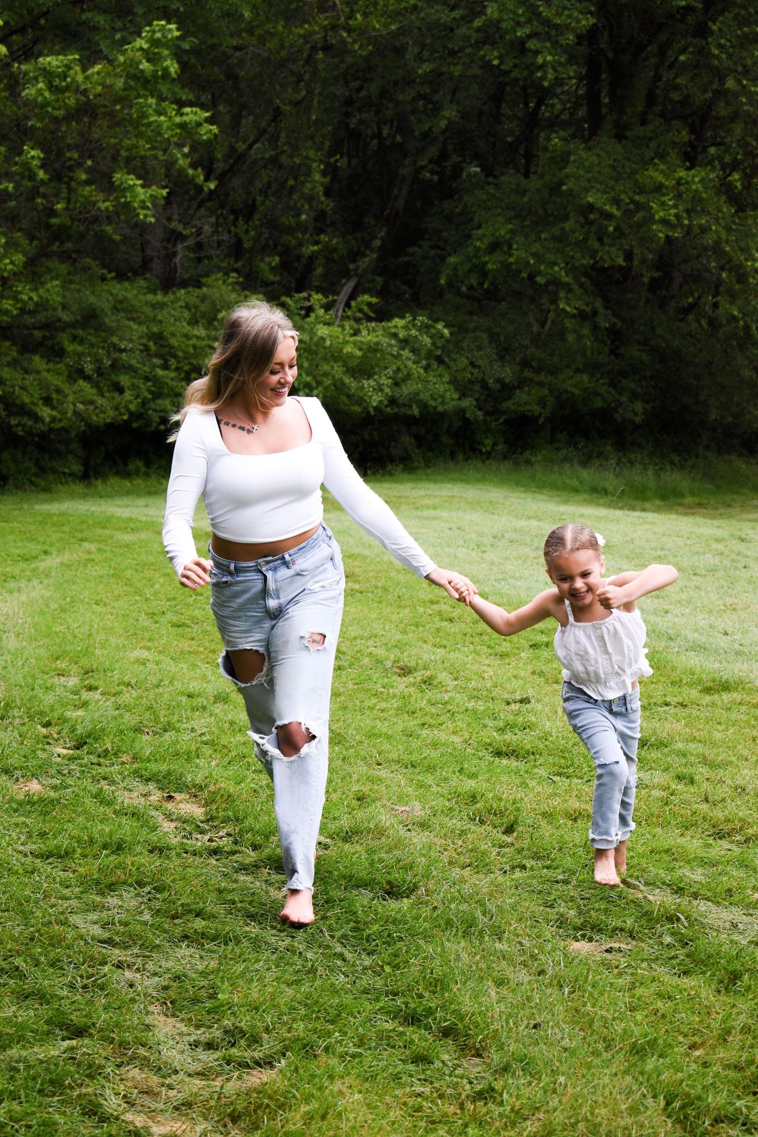 Playful running and dancing sequence on green grass outdoors.