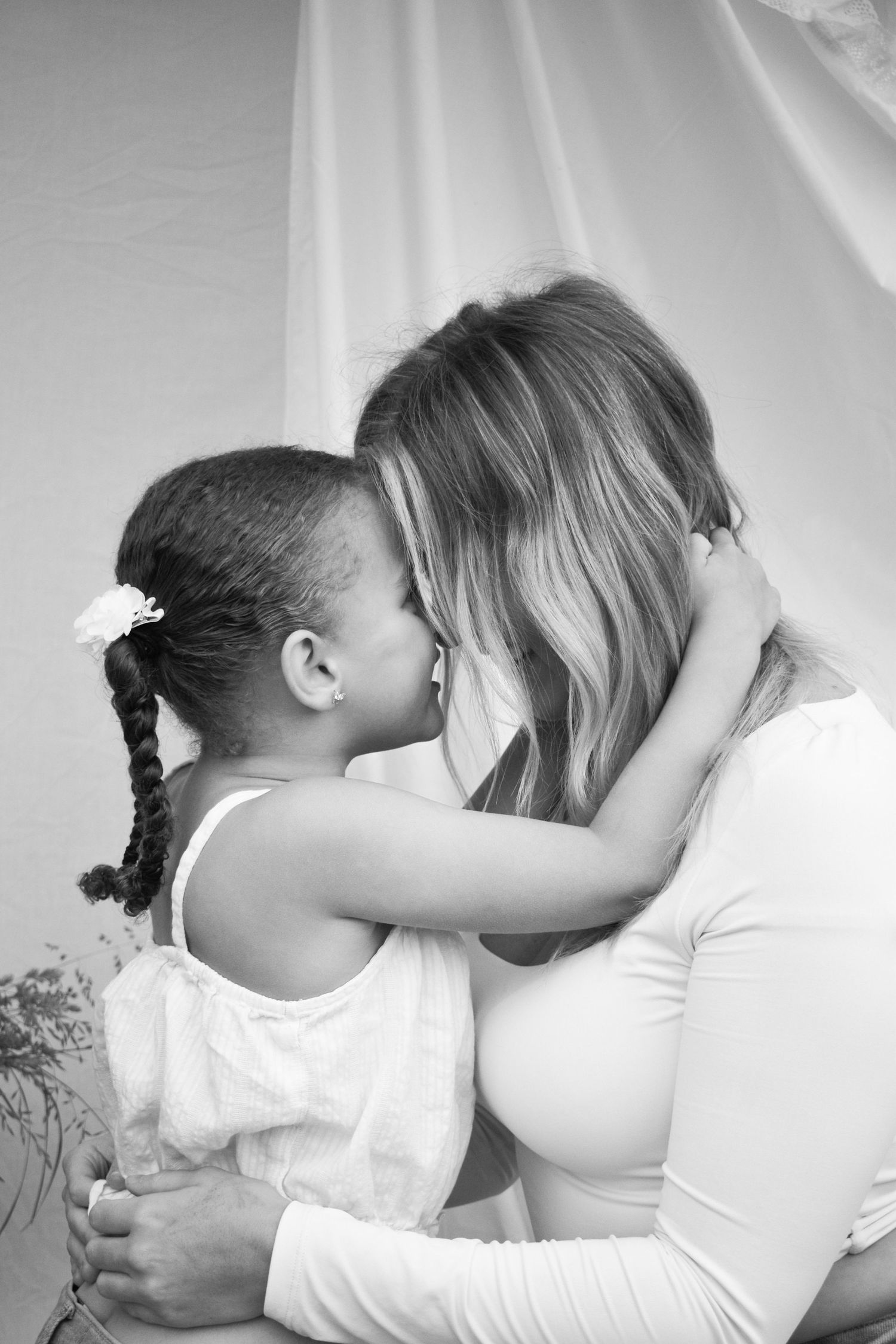 Black and white intimate portrait series against simple backdrop.