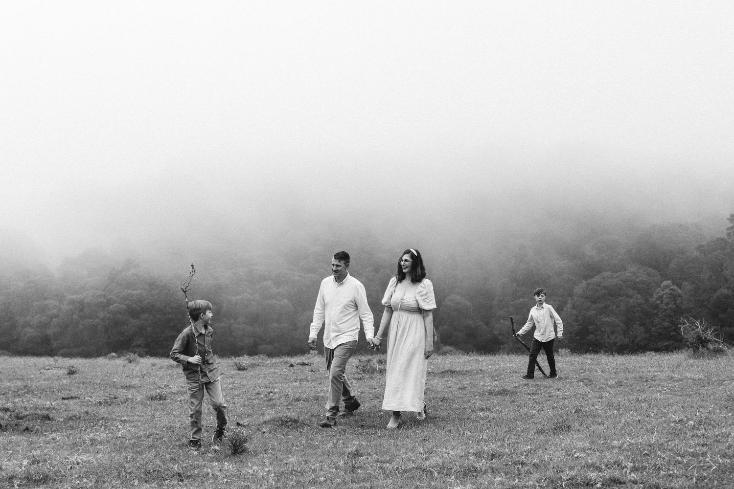 Family walking together through a misty mountain landscape. Robertson Southern Highlands