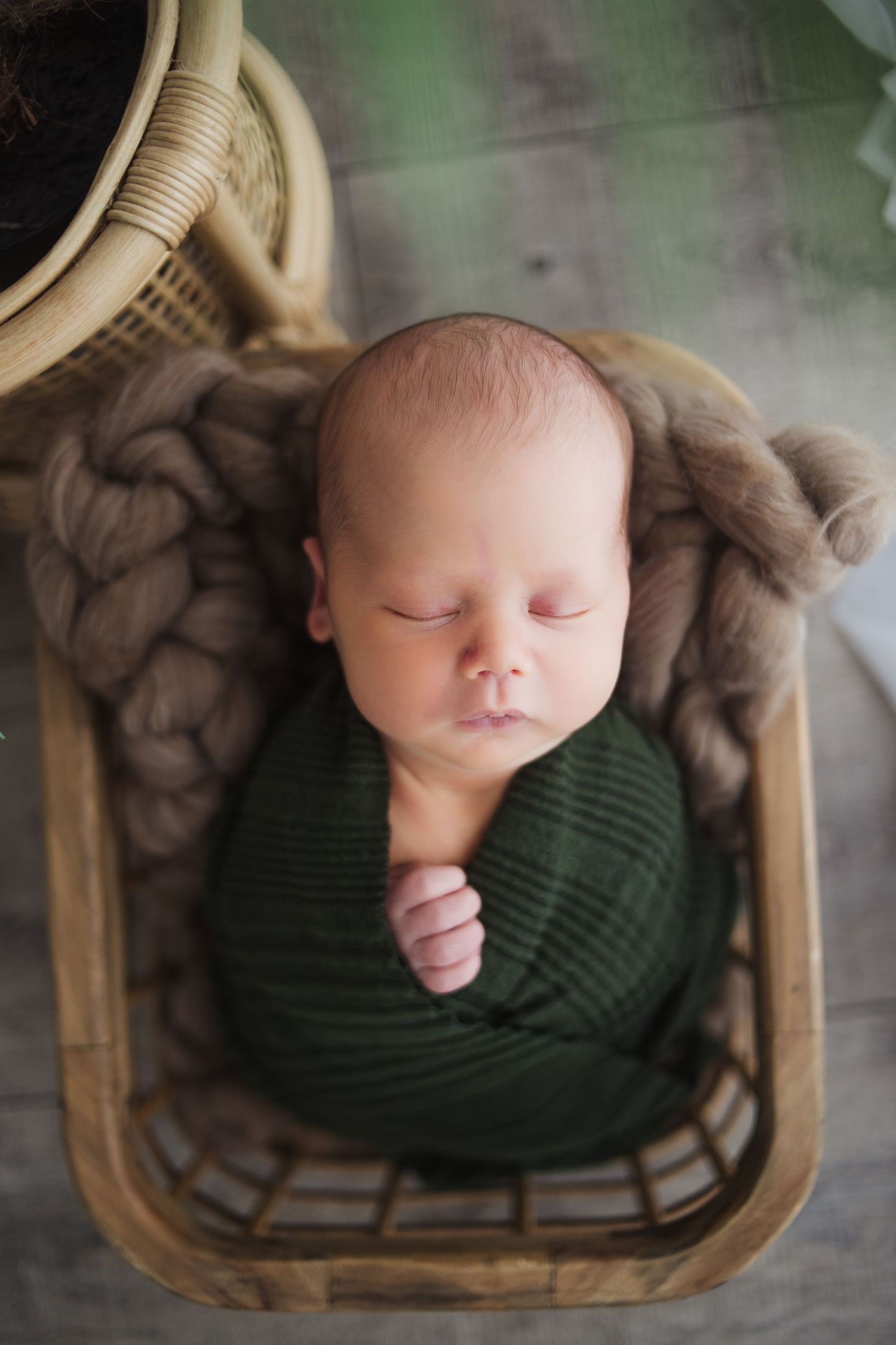 Swaddled newborn sleeping soundly in natural tones – professional baby photographer Springfield MO